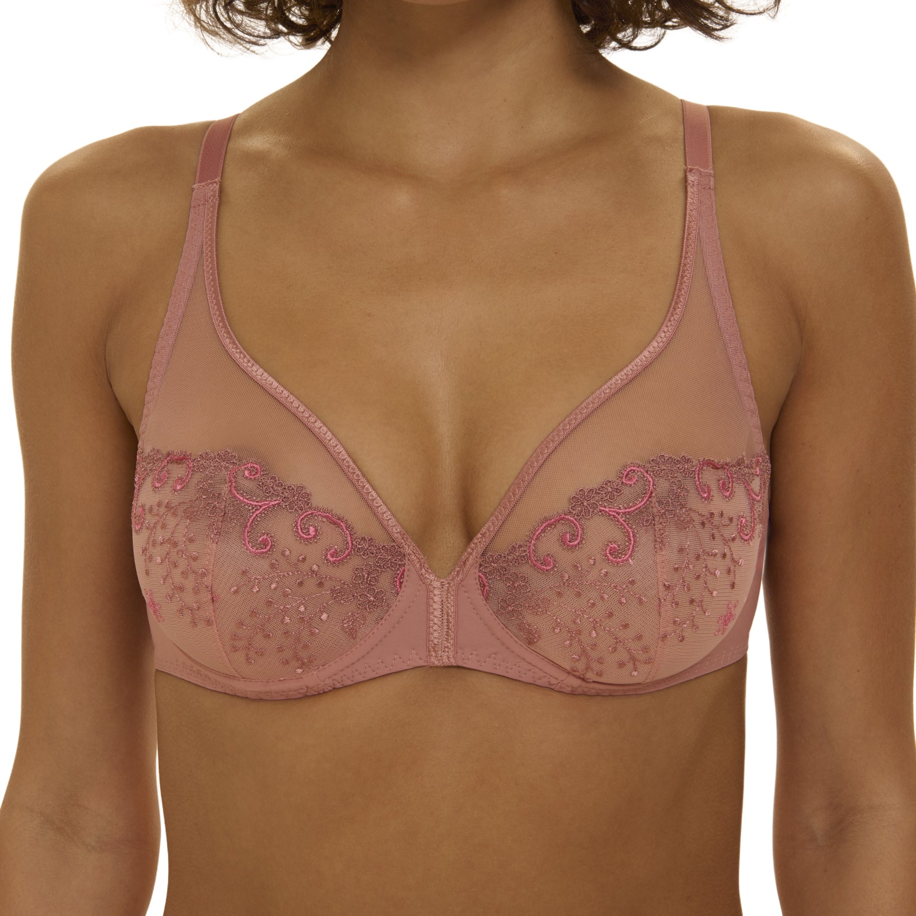 Front view of pink underwire bra with sheer embroidered lace cups and narrow straps, shown on model.