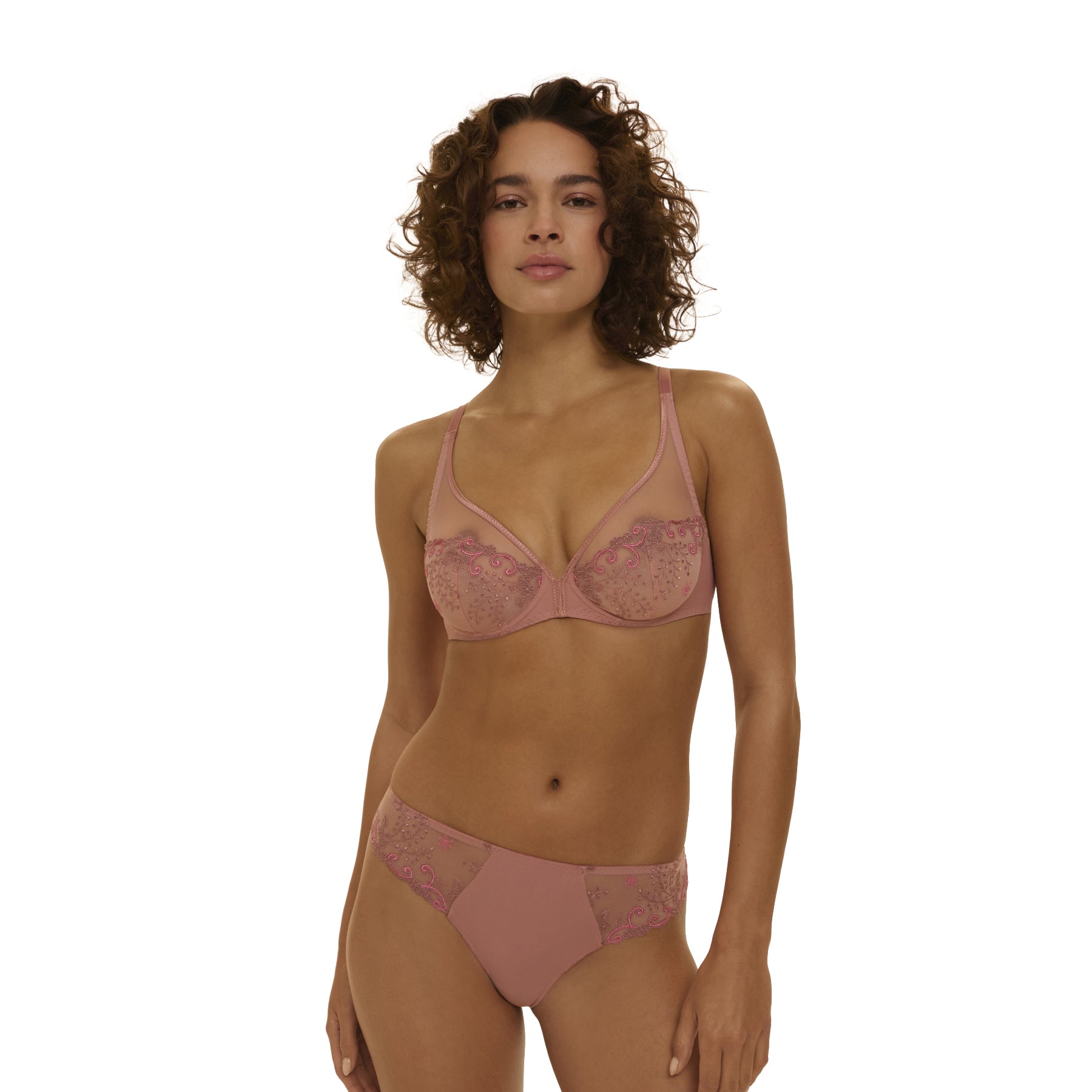 Three-quarter view of pink lace underwire bra and matching brief set, highlighting the fit and embroidery, shown on model.