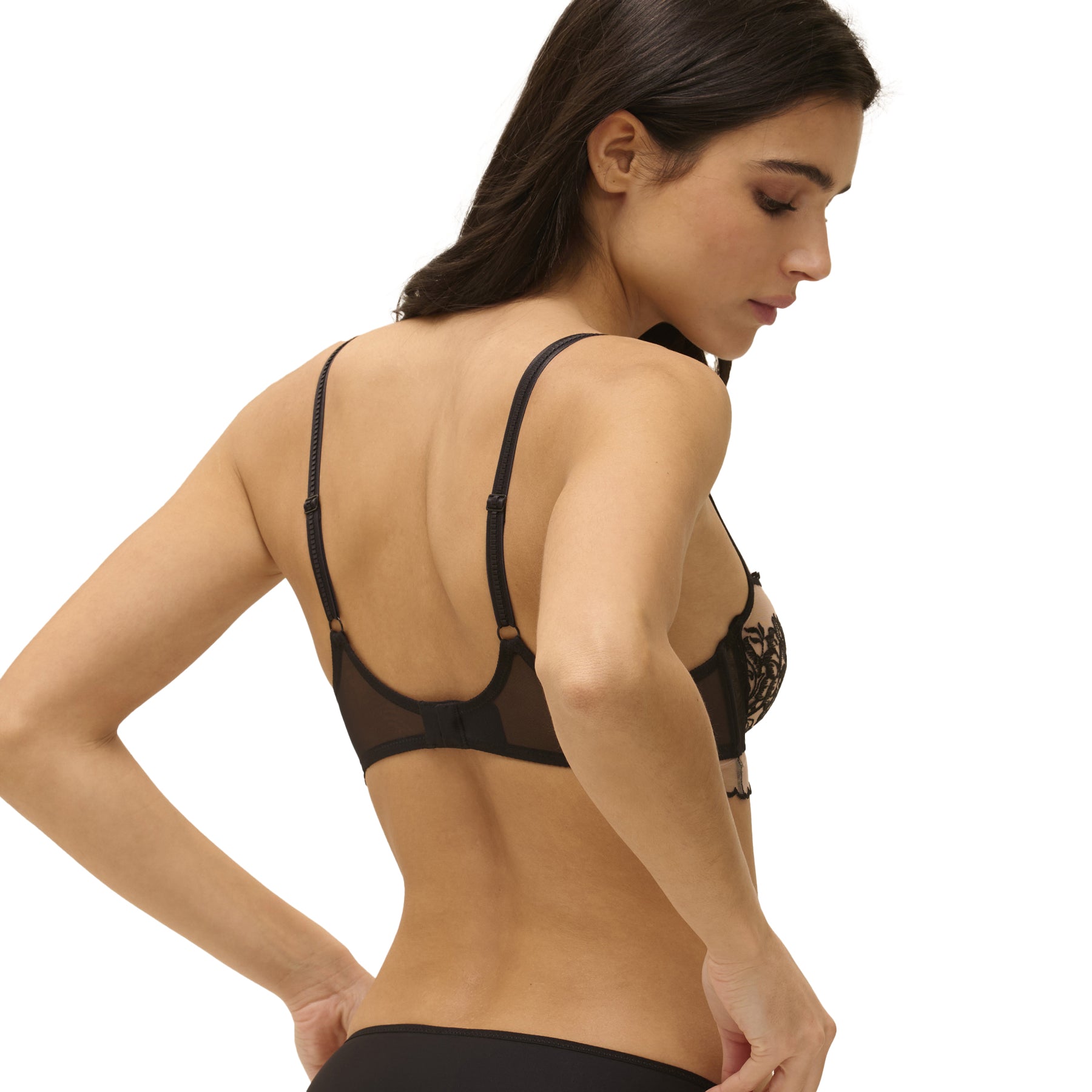 Black sheer bra with adjustable straps and floral embroidery, back view worn by model.