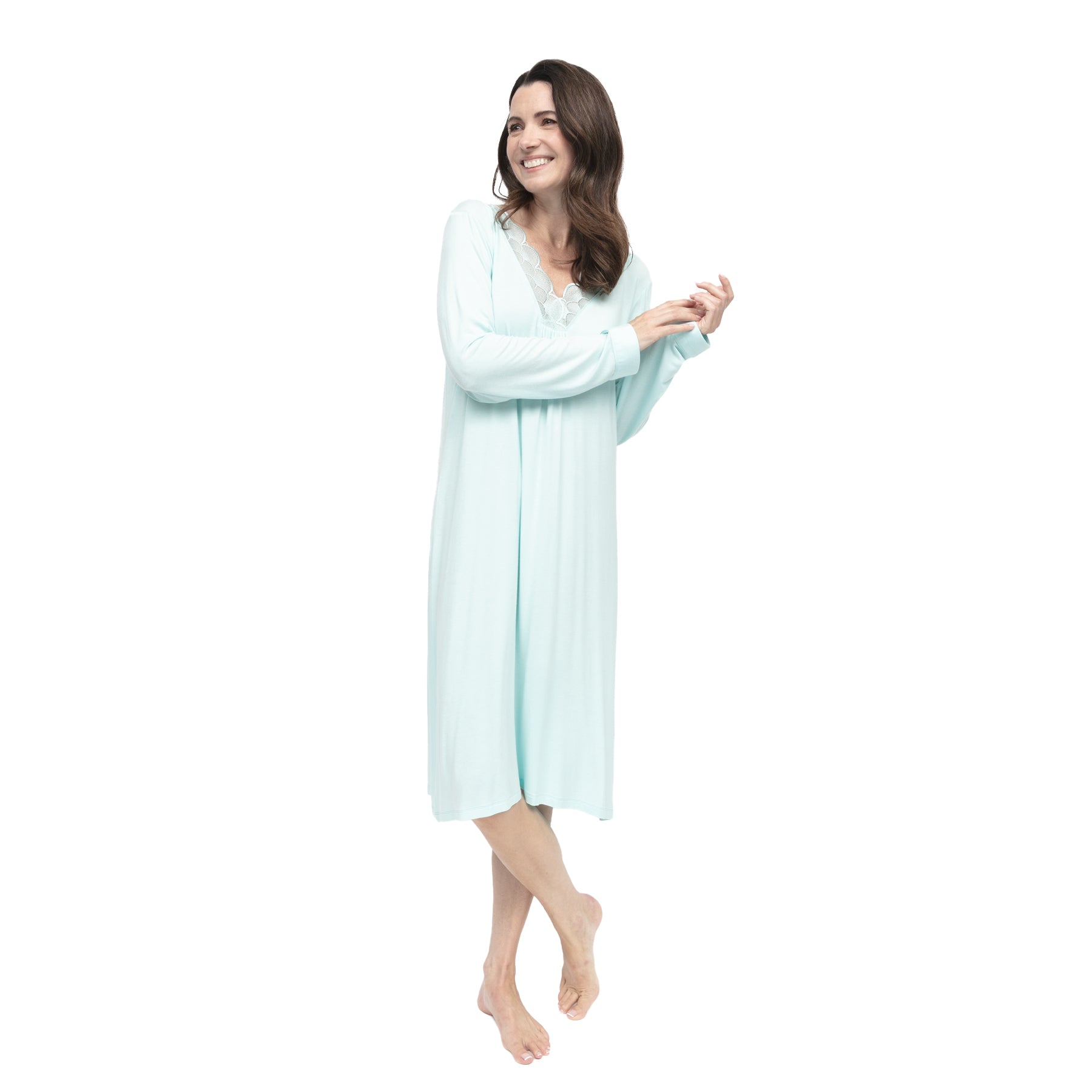 Model wearing light aqua long sleeve chemise with flowing drape and feminine lace neckline.