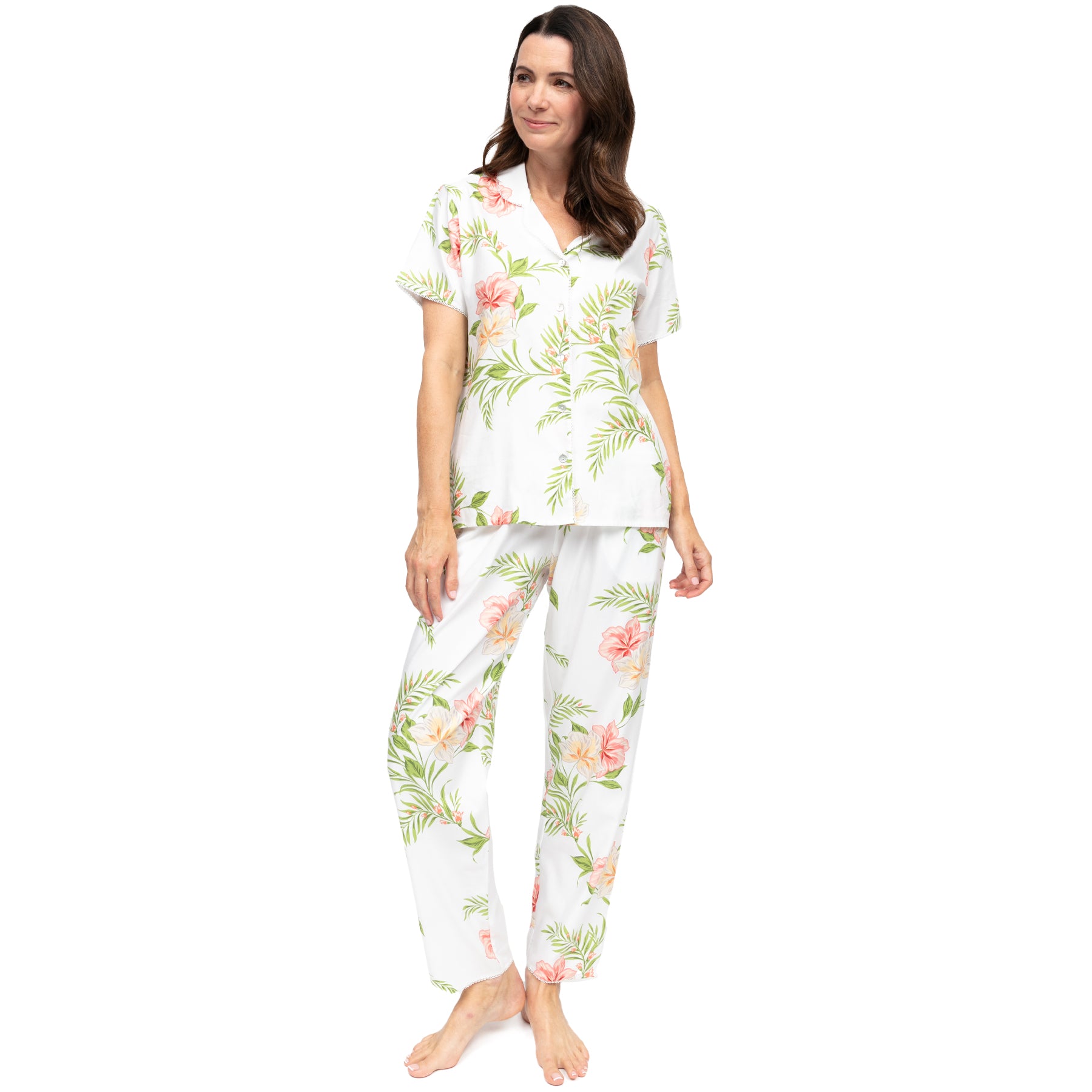 Women’s white floral pyjama set, front view, short sleeve button-up top and full-length pants in soft cotton with delicate hibiscus print, airy and comfortable fit