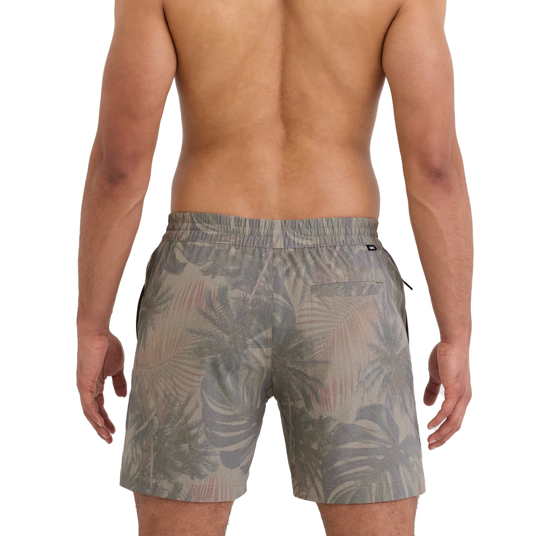 Back view of man wearing palm print swim shorts with elastic waistband and mid-length cut on a white background