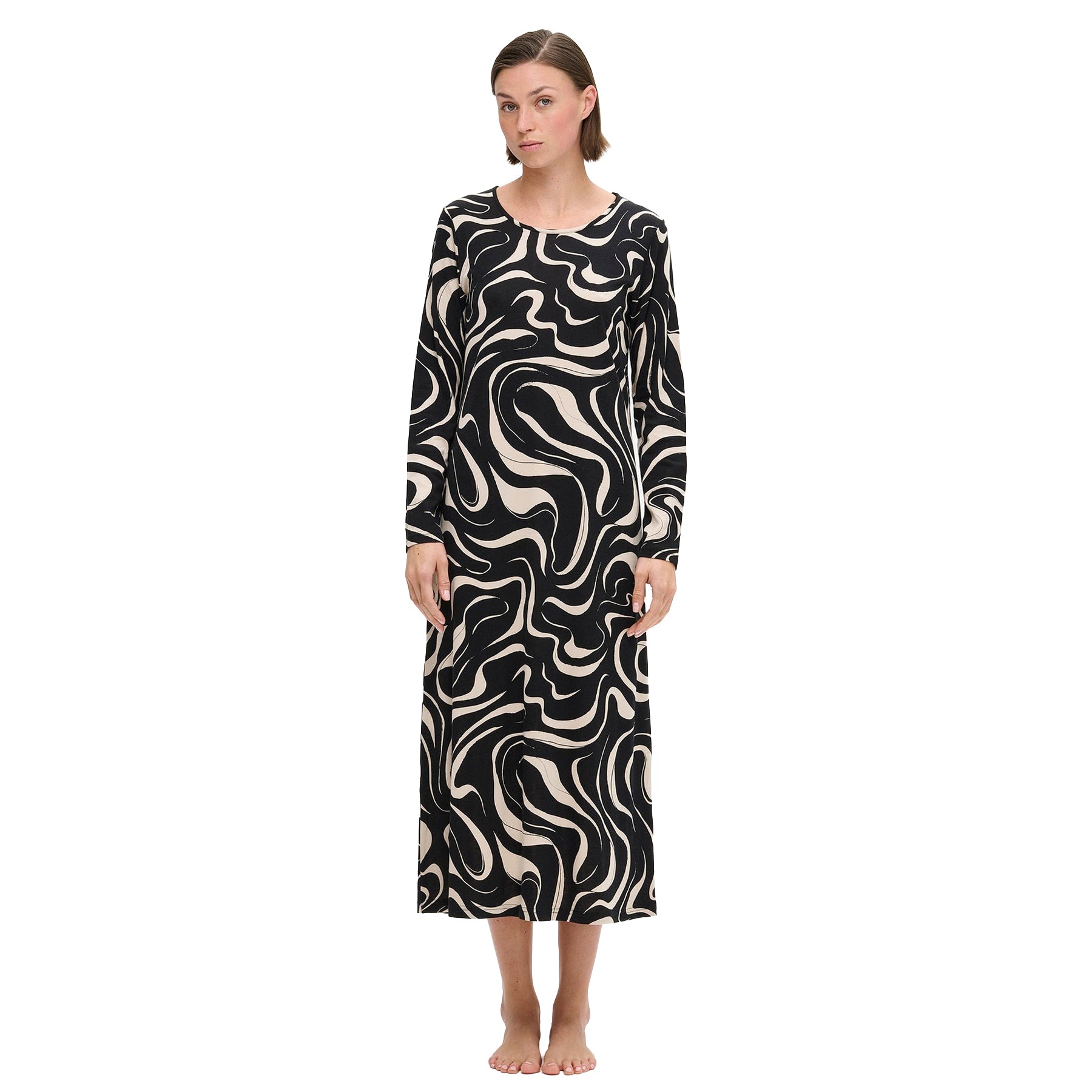 Black long-sleeve nightdress with cream abstract swirl print, ankle-length silhouette, shown on model standing barefoot against a white background.