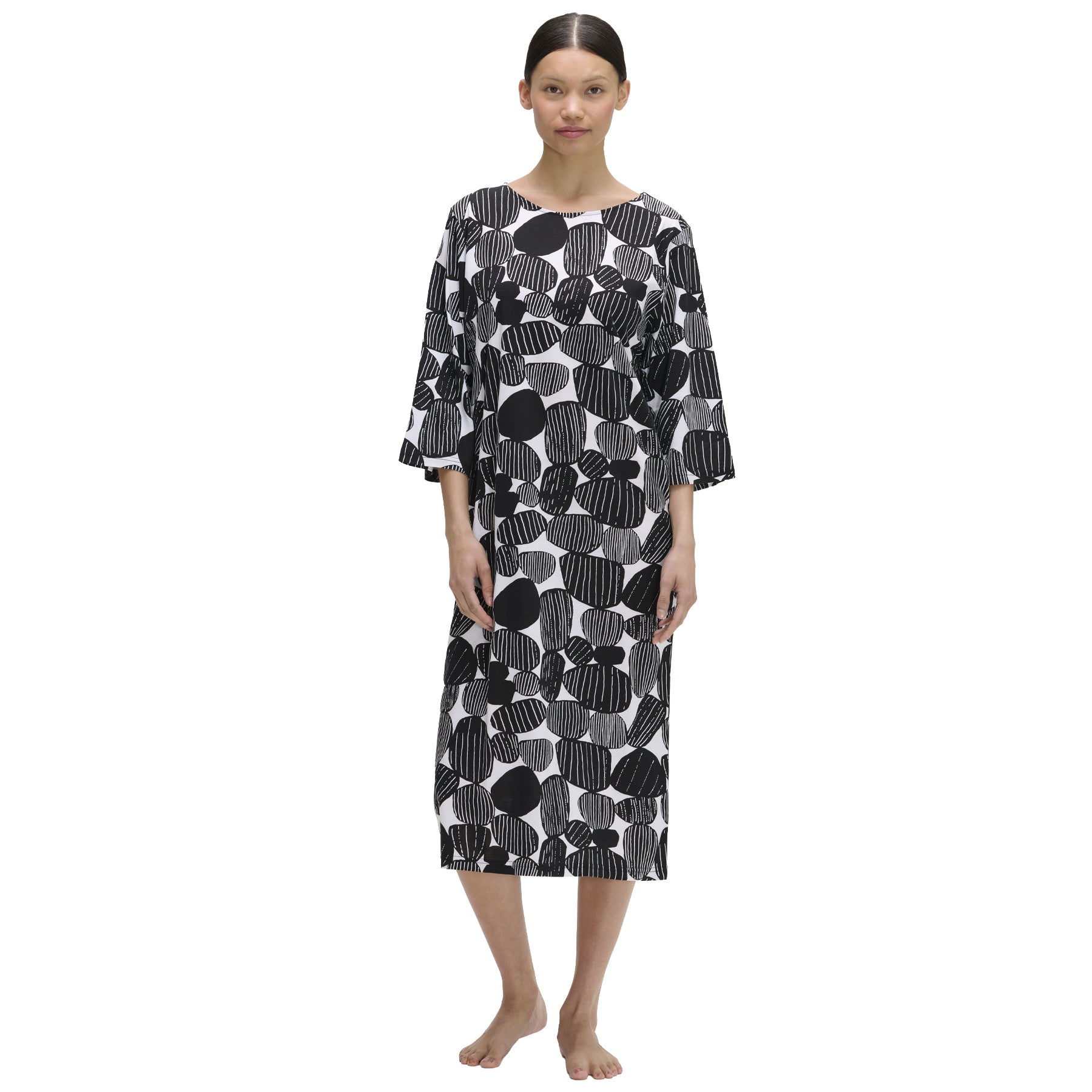 Black and white nightdress with abstract stone print and three-quarter sleeves, mid-calf length silhouette, shown on model standing barefoot against a white background.
