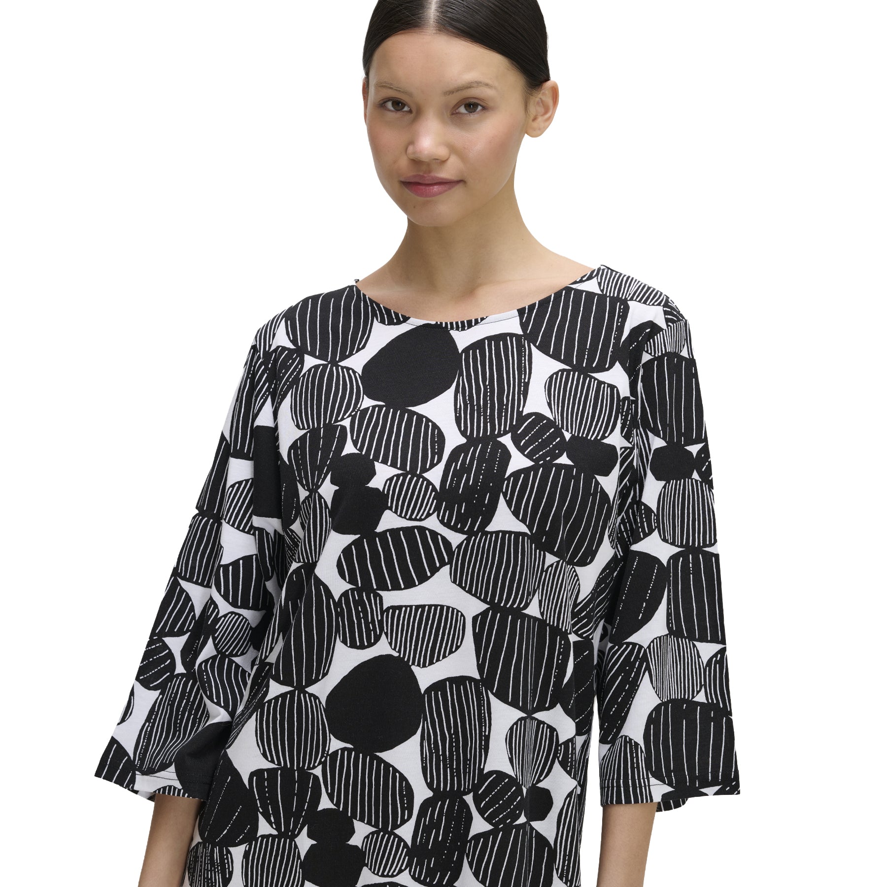 Close-up of black and white nightdress featuring an abstract stone pattern, round neckline, and three-quarter sleeves, shown on model.