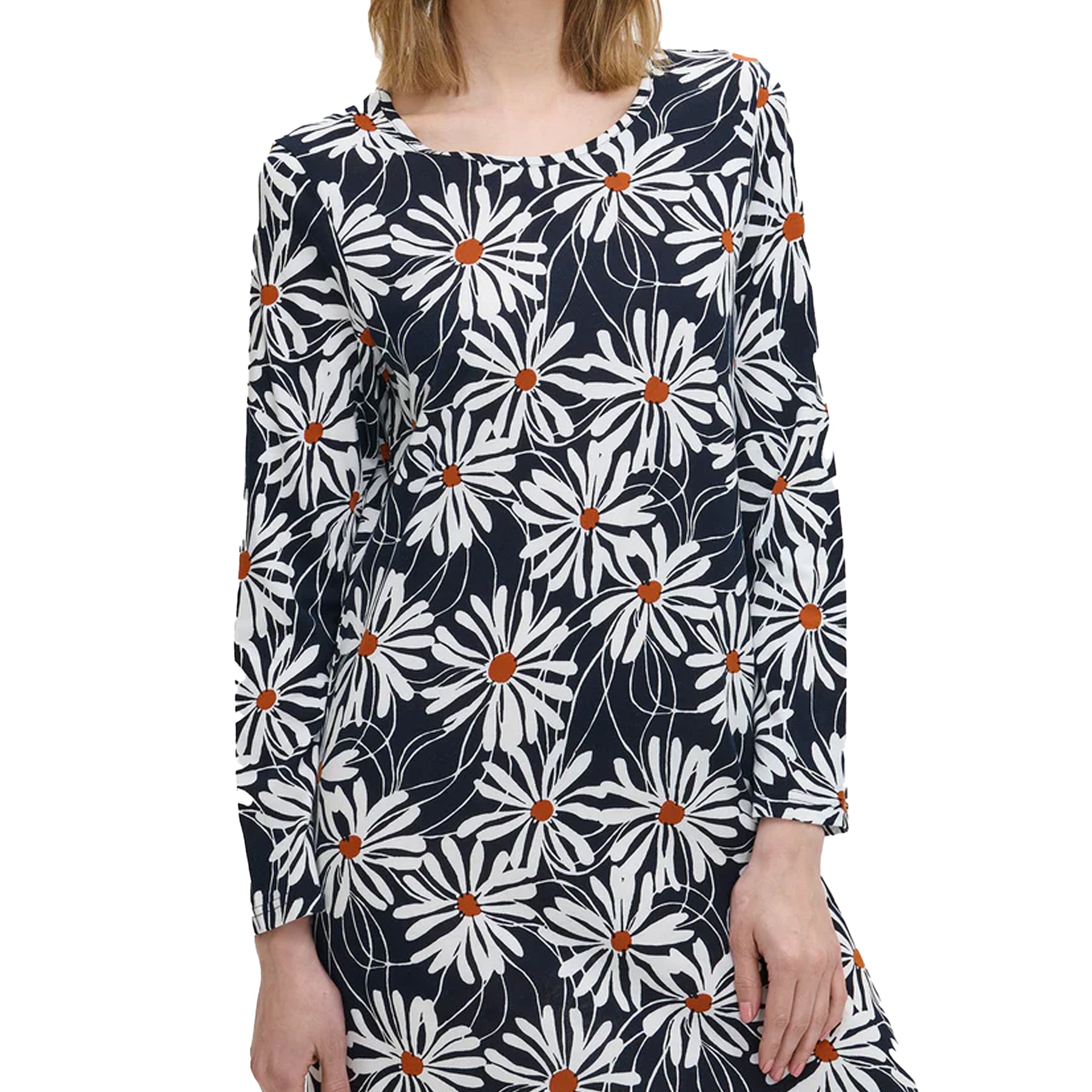 Woman wearing a navy long-sleeve nightdress with oversized white daisy print, showing soft cotton texture and round neckline detail.