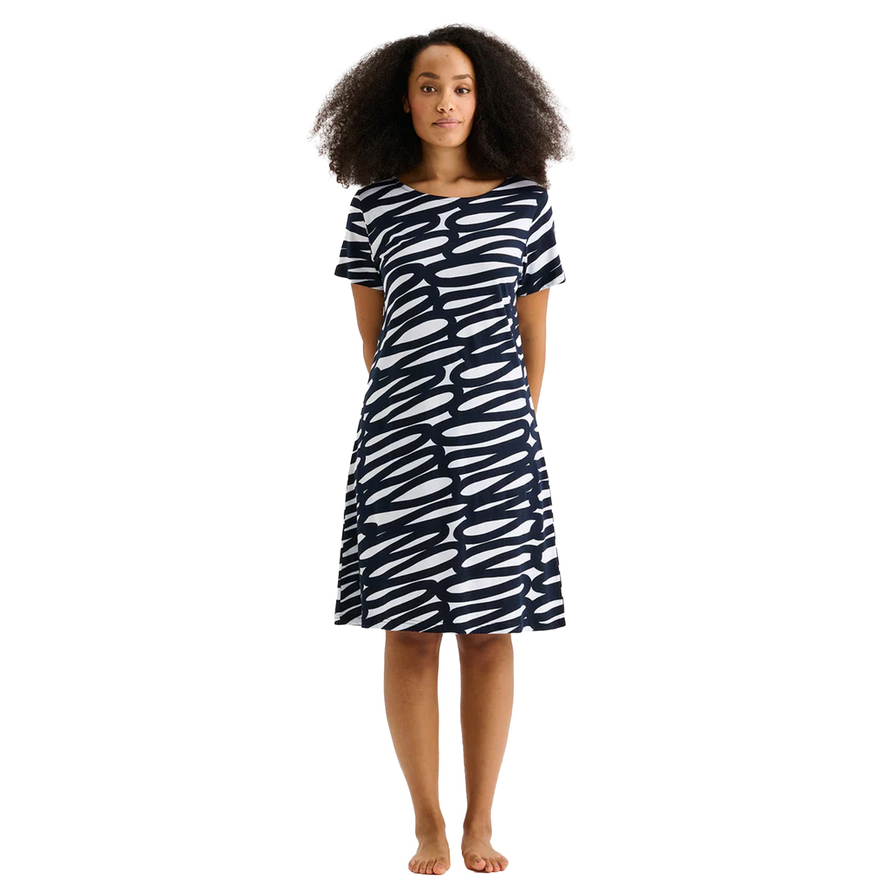 Woman wearing a navy and white abstract print short-sleeve nightdress with round neckline and relaxed knee-length silhouette.
