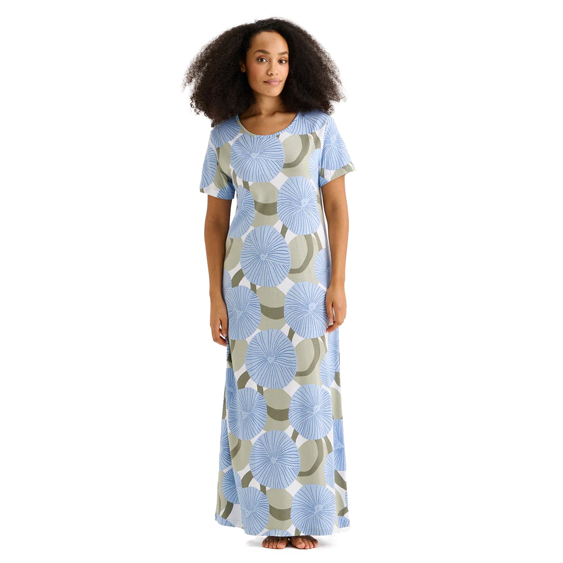 Woman wearing a long blue and sage green floral print nightgown with short sleeves and round neckline.