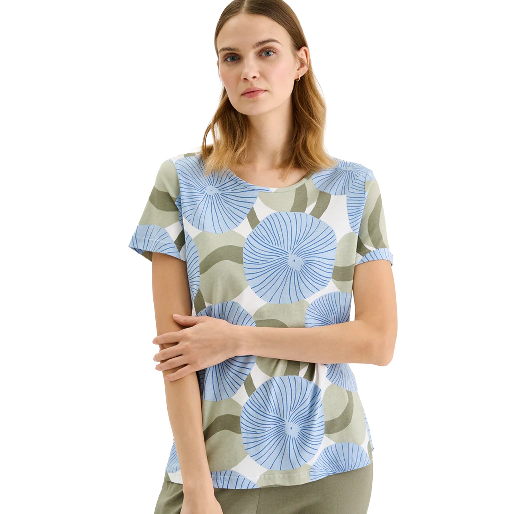 Close-up of blue circular floral print short-sleeve pajama top paired with sage green lounge pants on model.