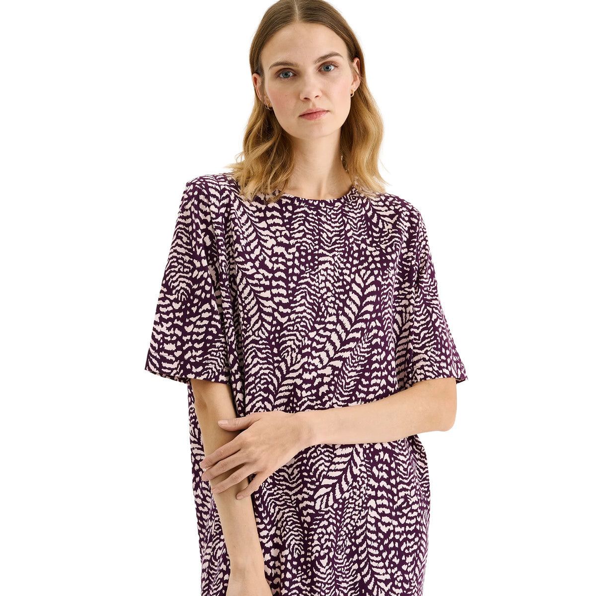 Close-up of Nanso Fiona Gown featuring an all-over purple and beige abstract pattern and round neckline