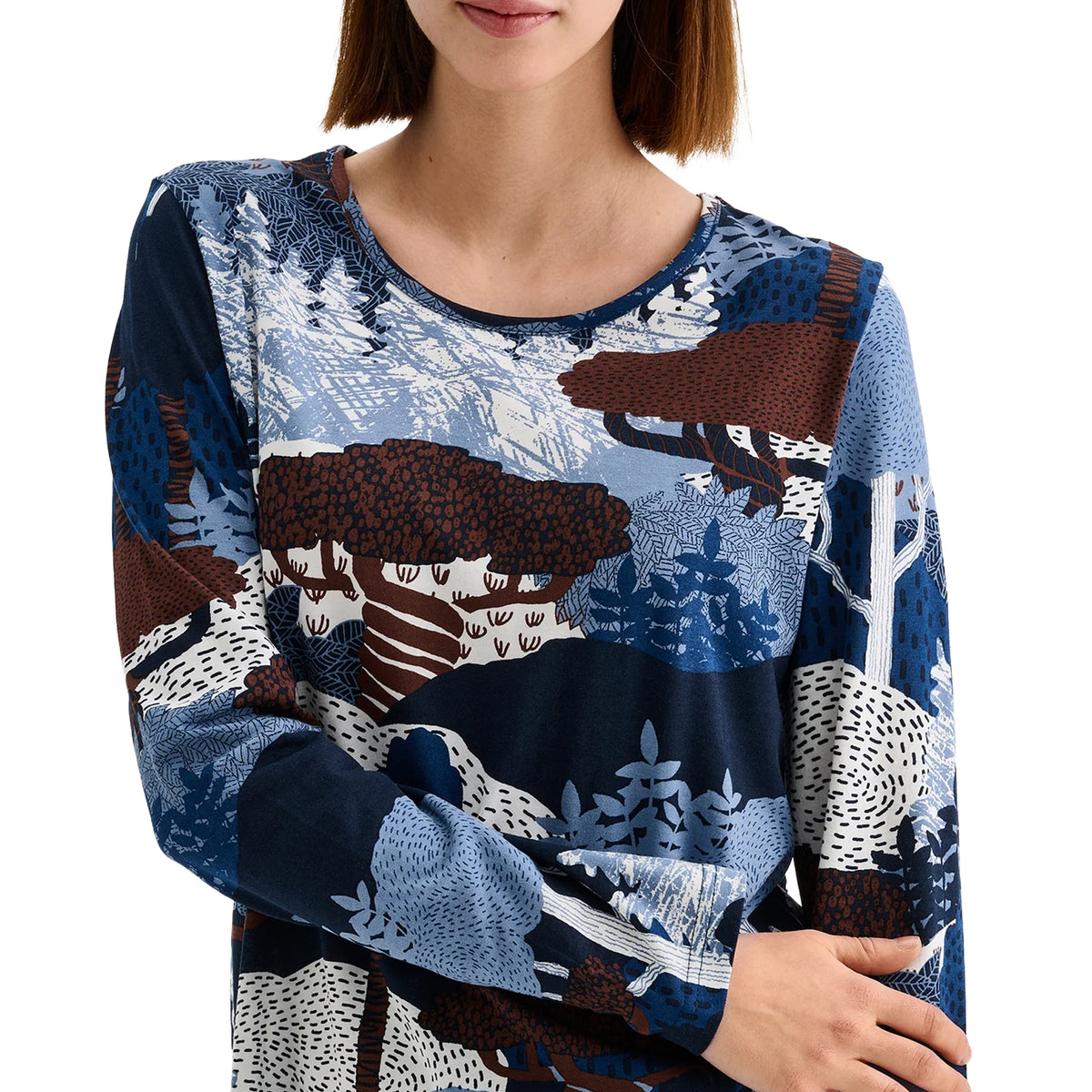 Close-up of Nanso pajama top showing blue, navy and brown woodland print with round neckline