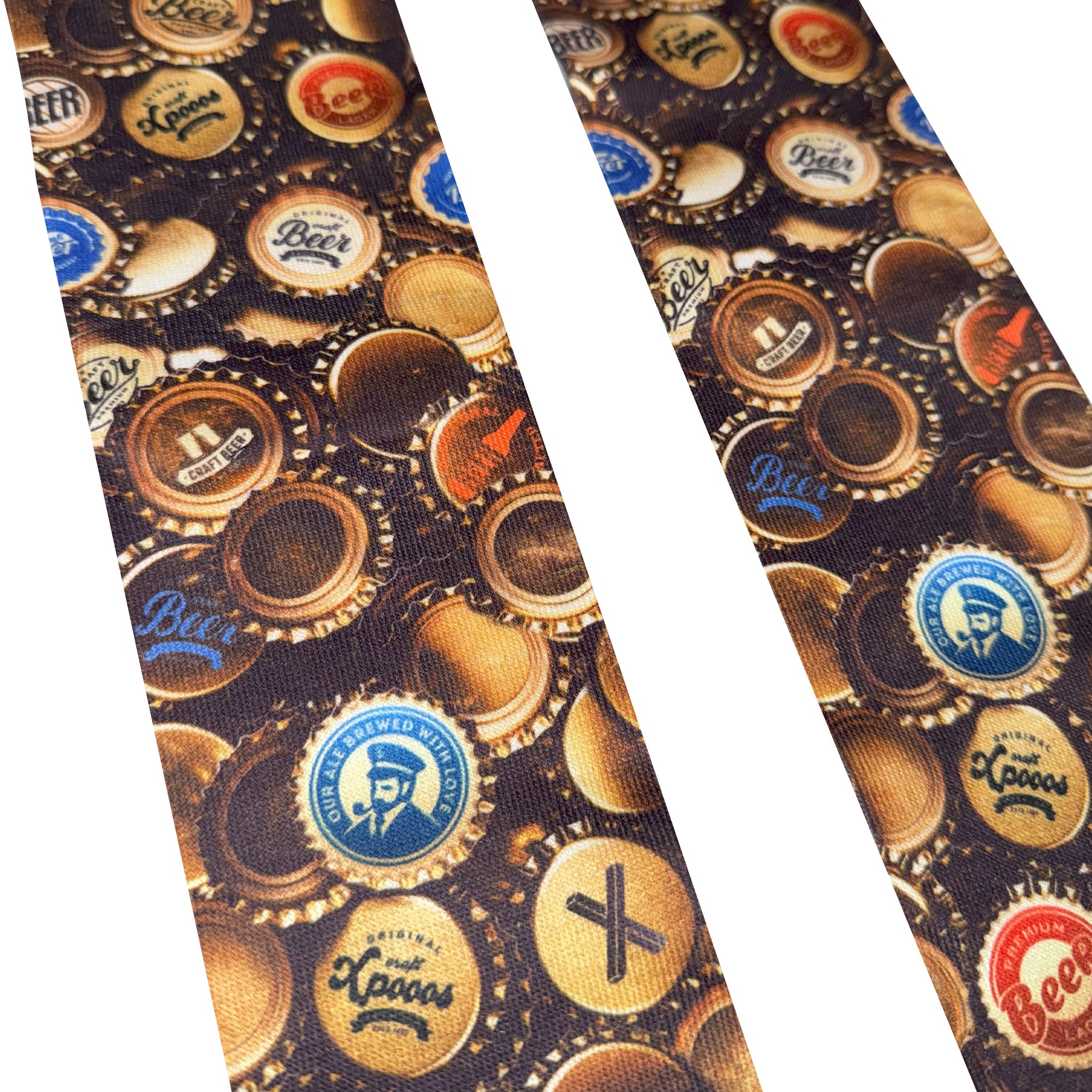 Close-up of patterned fabric featuring colourful beer bottle caps in gold, blue, red, and brown tones.