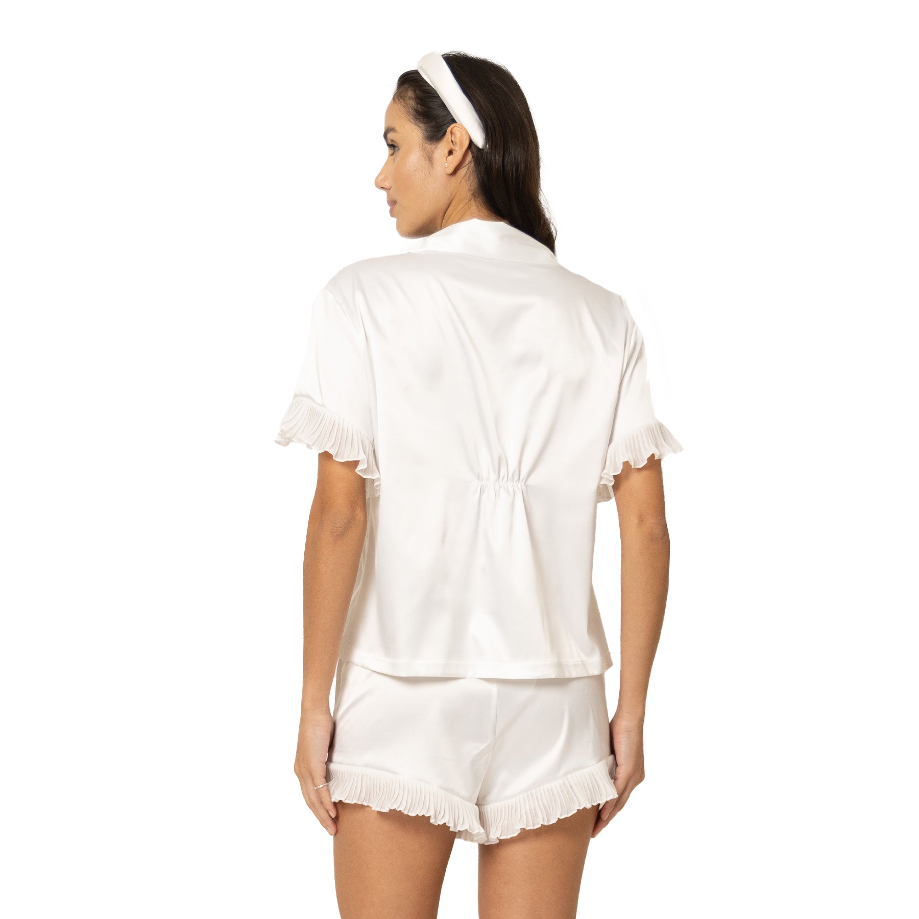 Back view of off-white satin pyjama set with short sleeve shirt and ruffle trim shorts
