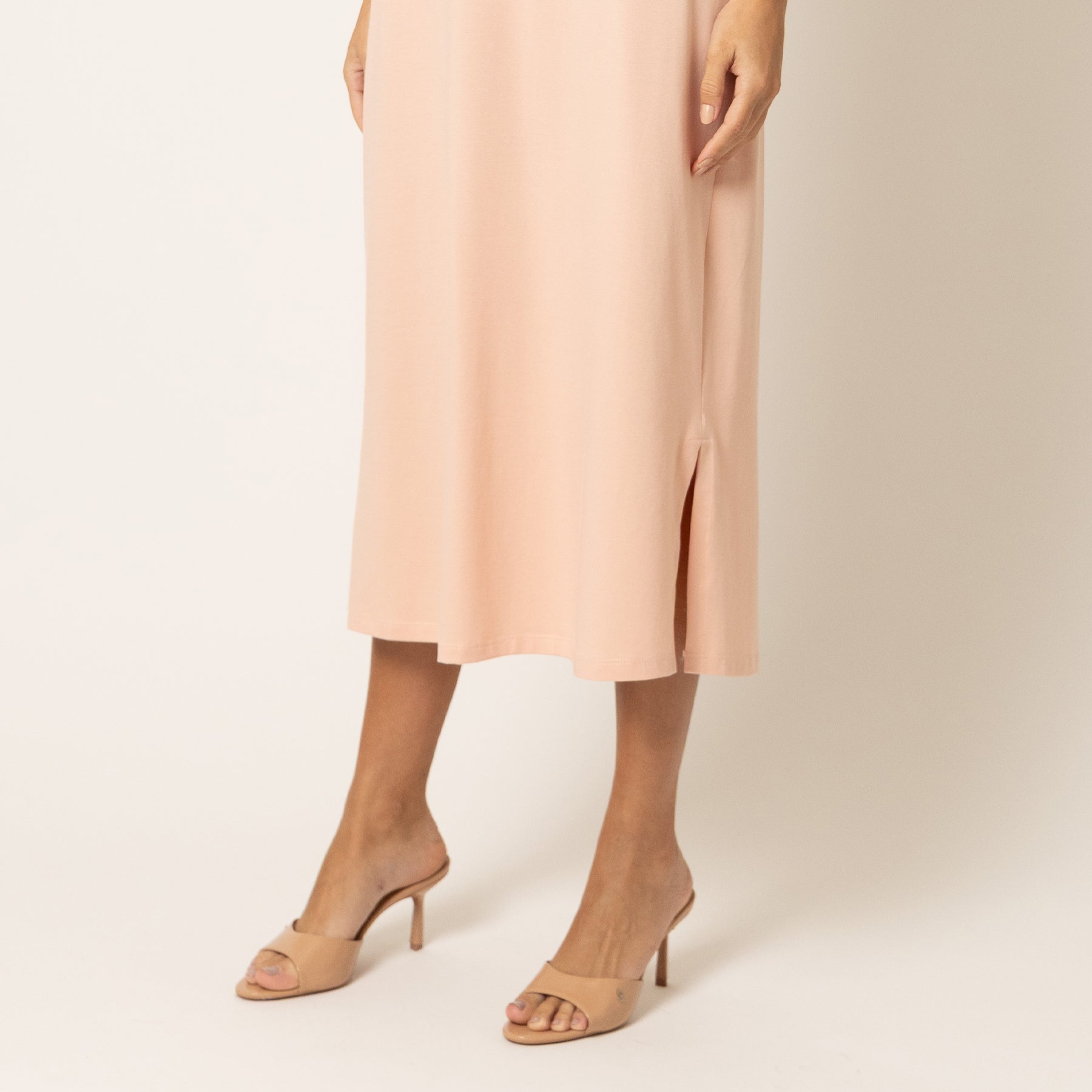 Lightweight blush pink sleep dress with side slit and fluid drape, lower detail view