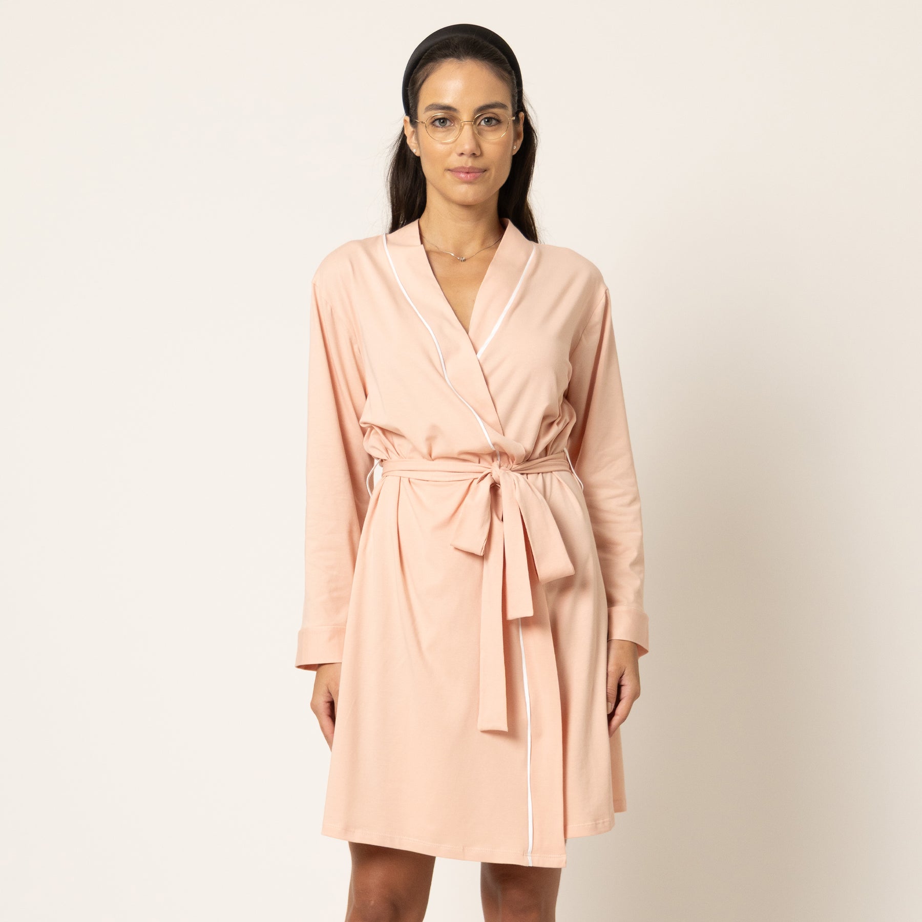 Blush pink short robe with wrap silhouette and belt, relaxed fit, angled front view