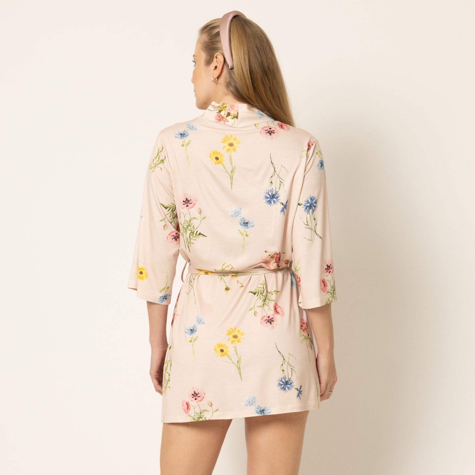 Back view of beige floral robe with soft floral print and adjustable belt detail