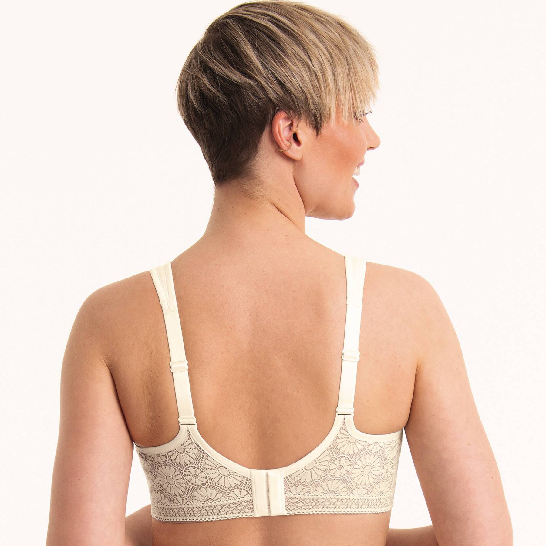 Back view of ivory bra on model showing adjustable straps and lace back band