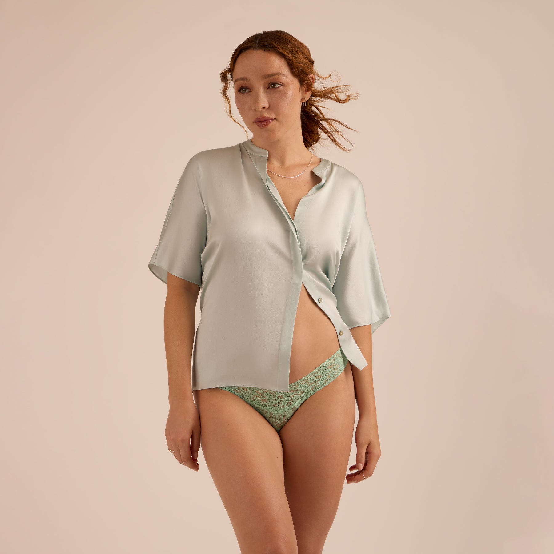 Model wearing a mint lace thong paired with a soft sage short-sleeve top, showcasing a relaxed yet refined lingerie look.