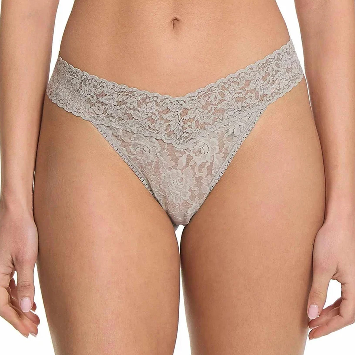 Model wearing the Hanky Panky Signature Lace Original Rise Thong in light Grey, featuring intricate floral lace, a wide scalloped waistband, and a V-shaped front.