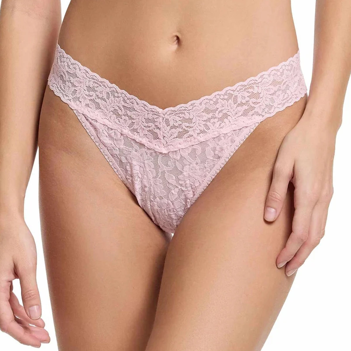 Model wearing the Hanky Panky Signature Lace Original Rise Thong in Bliss Pink, featuring sheer floral lace, a wide scalloped waistband, and a flattering V-shaped front.