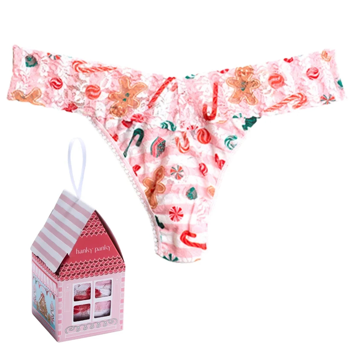 Hanky Panky Signature Lace Original Rise Thong in Sugar and Spice holiday print, featuring pink floral lace with gingerbread cookies, candy canes, and peppermint candies, displayed with a festive pink house-shaped gift box.