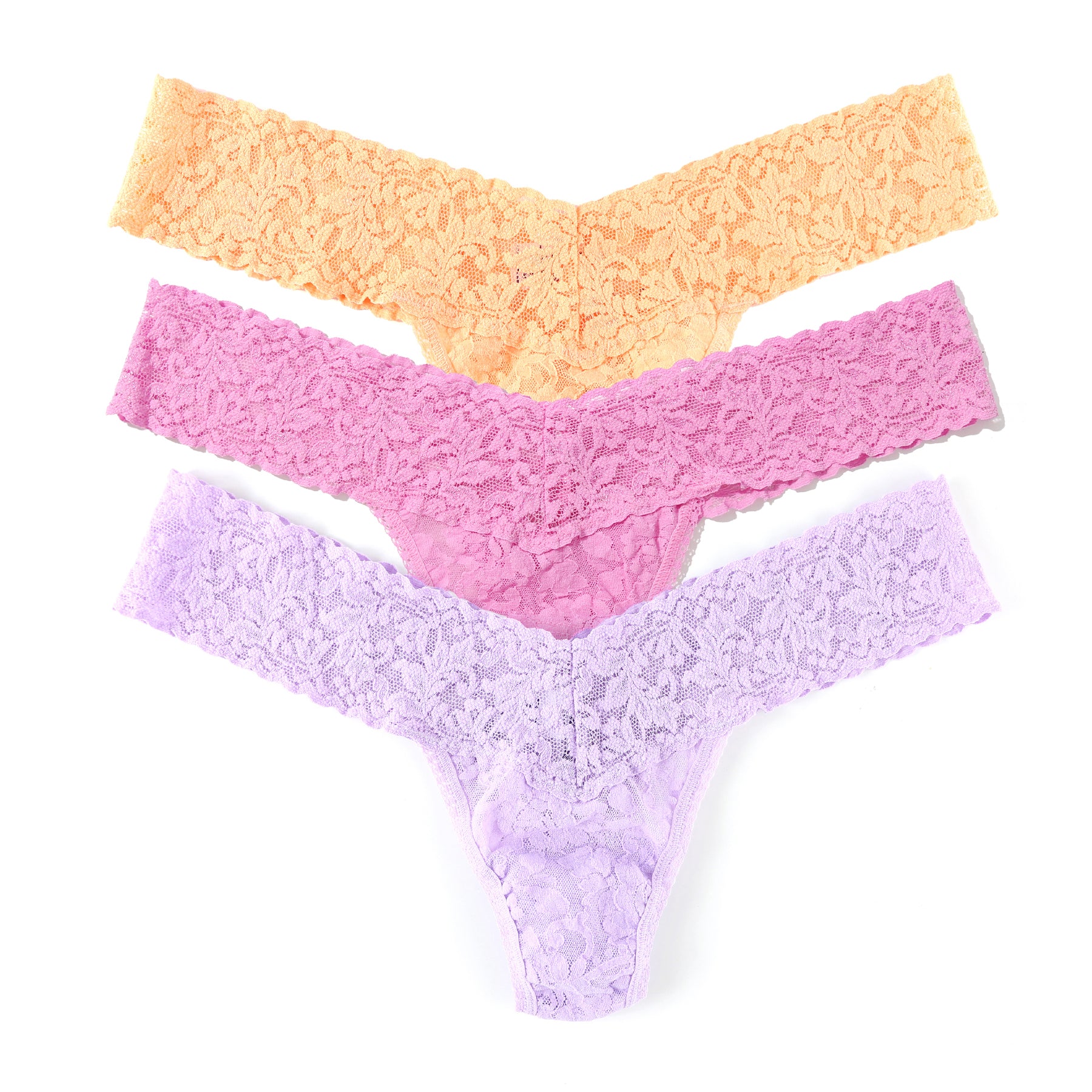 Flat lay of Hanky Panky lace thongs in pastel yellow, pink, and lavender colours.