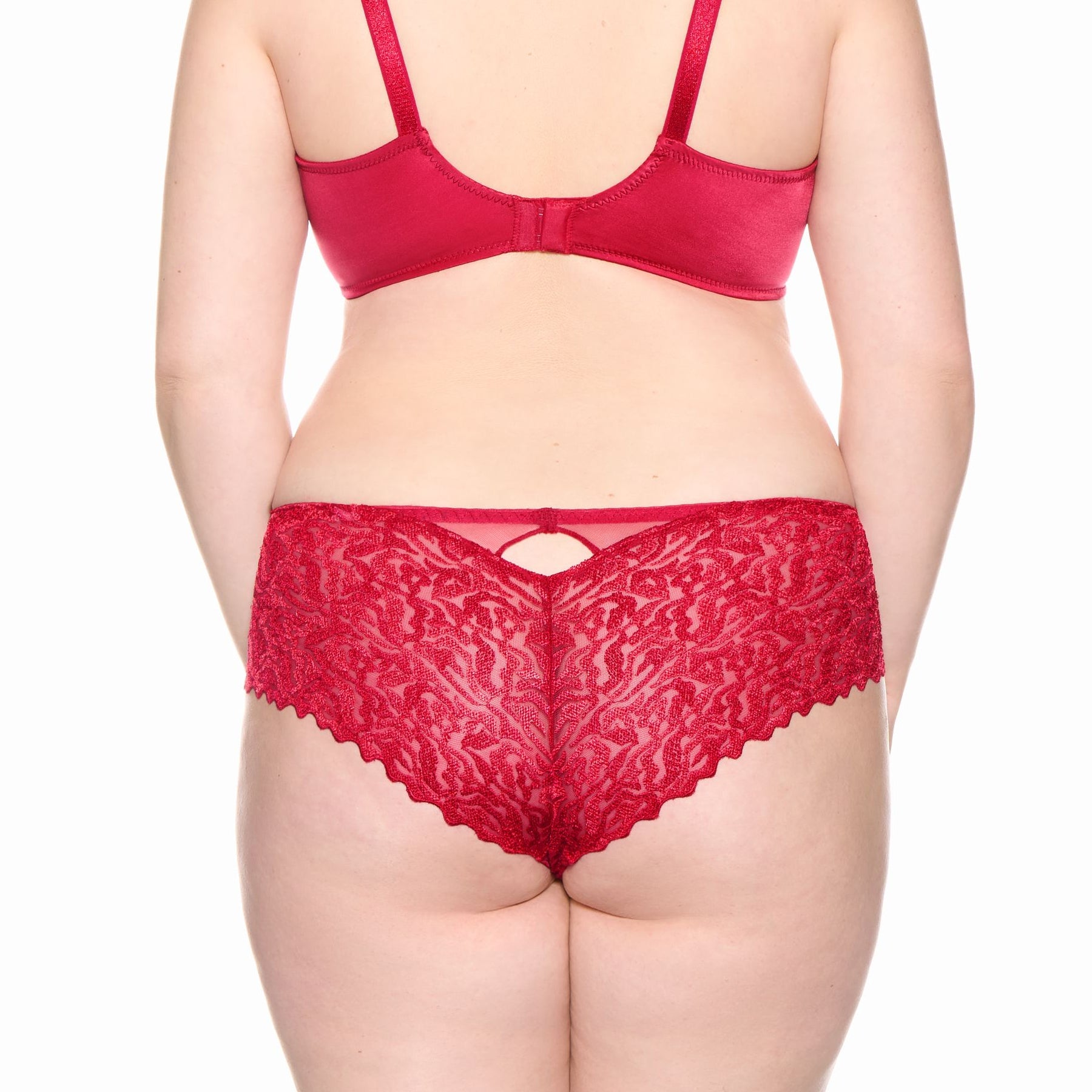 Back view of model wearing Louisa Bracq Waves briefs in red, featuring sheer wave-pattern lace and scalloped edges.