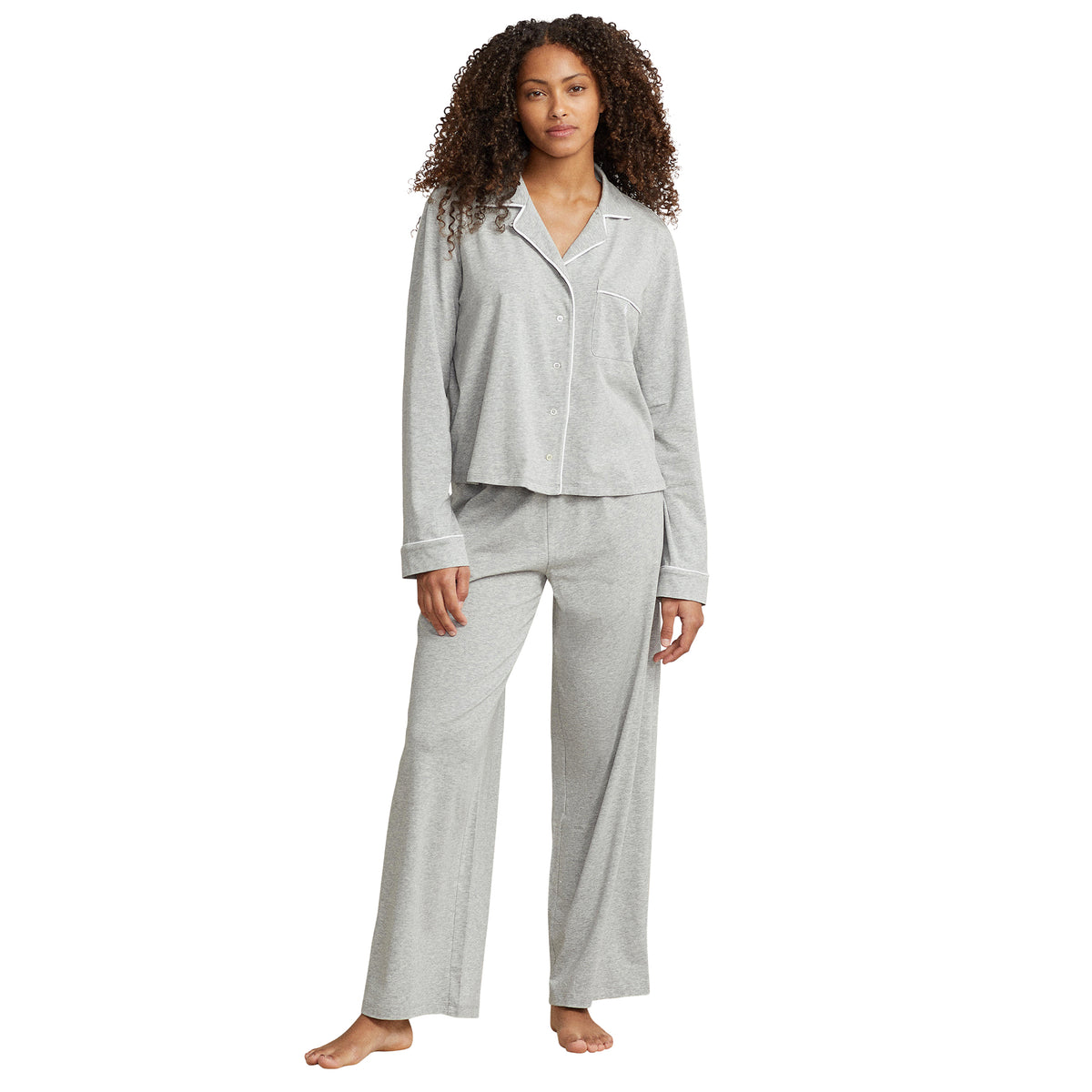 Model wearing Polo Ralph Lauren heather grey button-up pyjama set with long sleeves, white piping, chest pocket, and matching relaxed-fit pants.