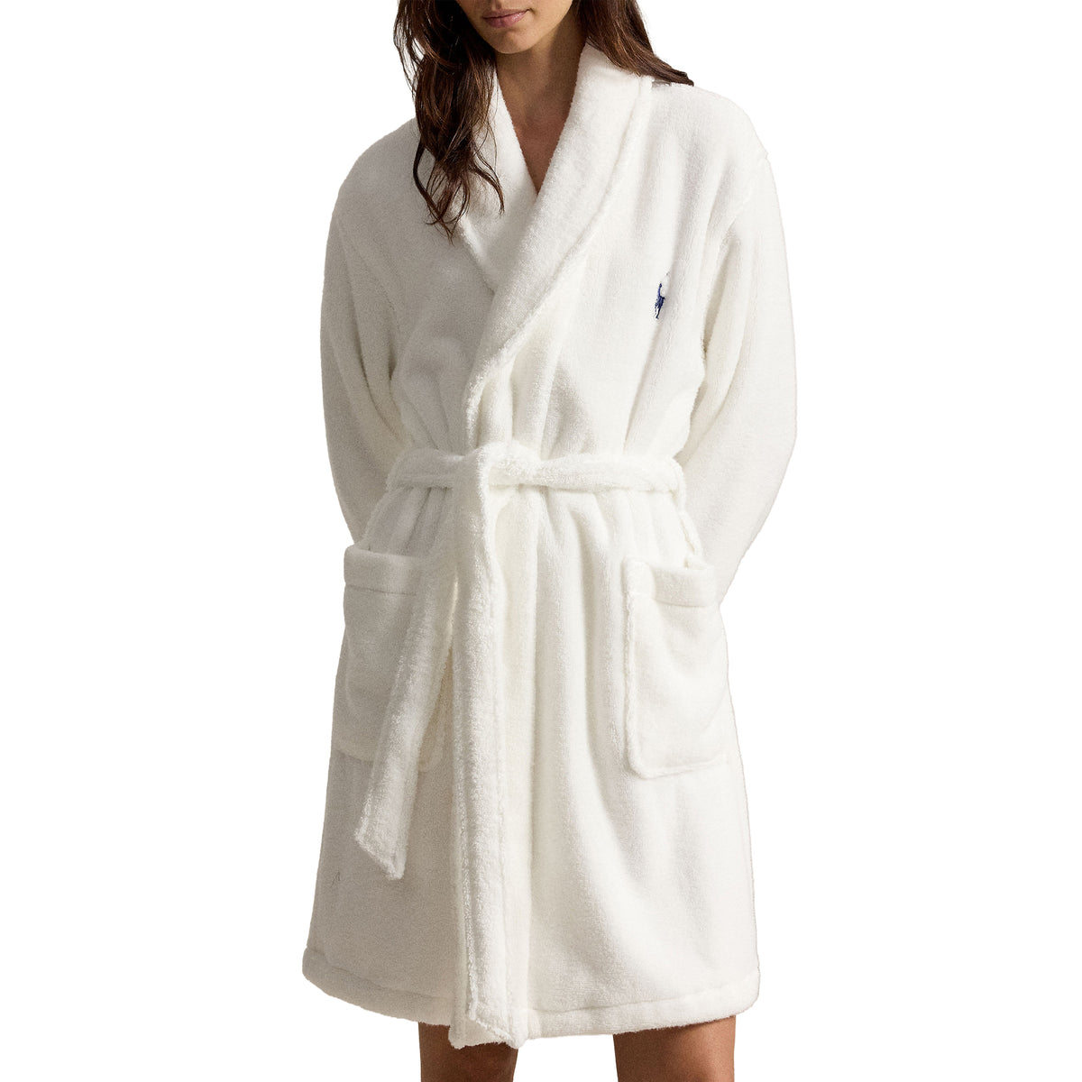 Close-up of Polo Ralph Lauren white fleece bathrobe showcasing the soft plush texture, shawl collar, matching waist tie, spacious front pockets, and embroidered Polo logo.