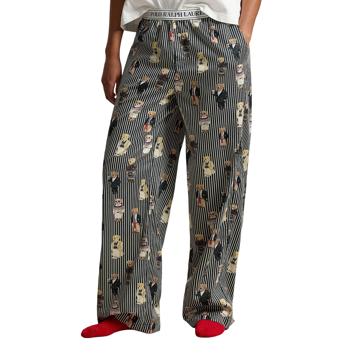 Close-up of Polo Ralph Lauren striped pajama pants showcasing the relaxed wide-leg fit, playful Polo Bear illustrations, side pockets, and signature logo waistband.