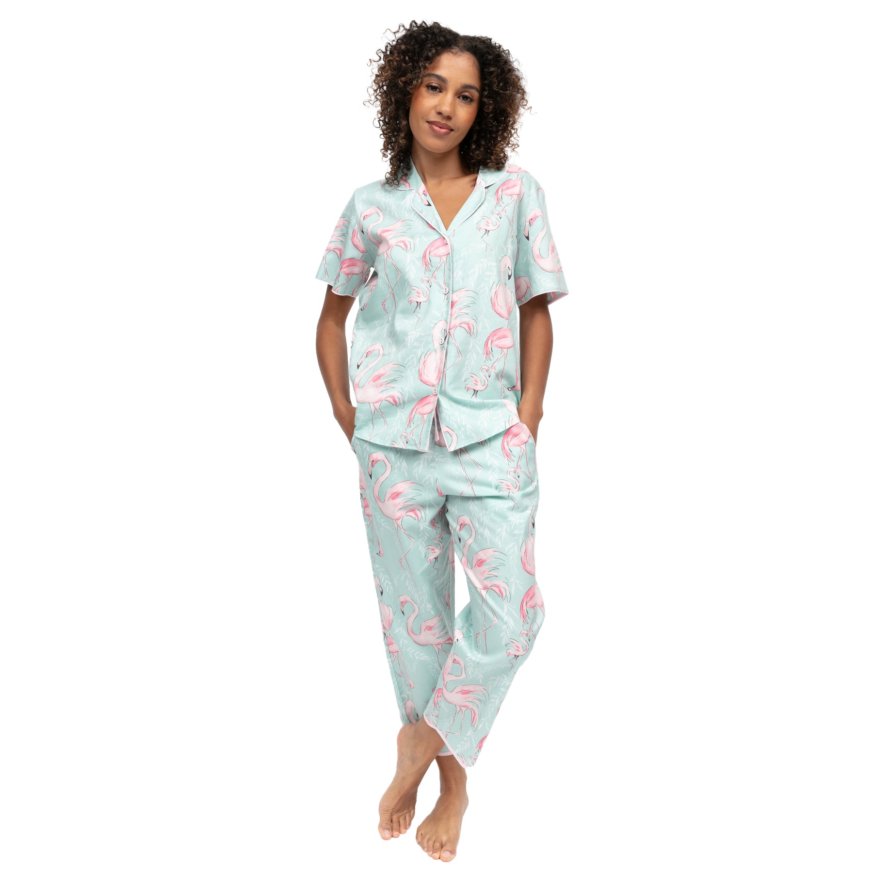 Woman wearing mint flamingo print pyjama set with short sleeve shirt and relaxed fit pants, soft lightweight fabric