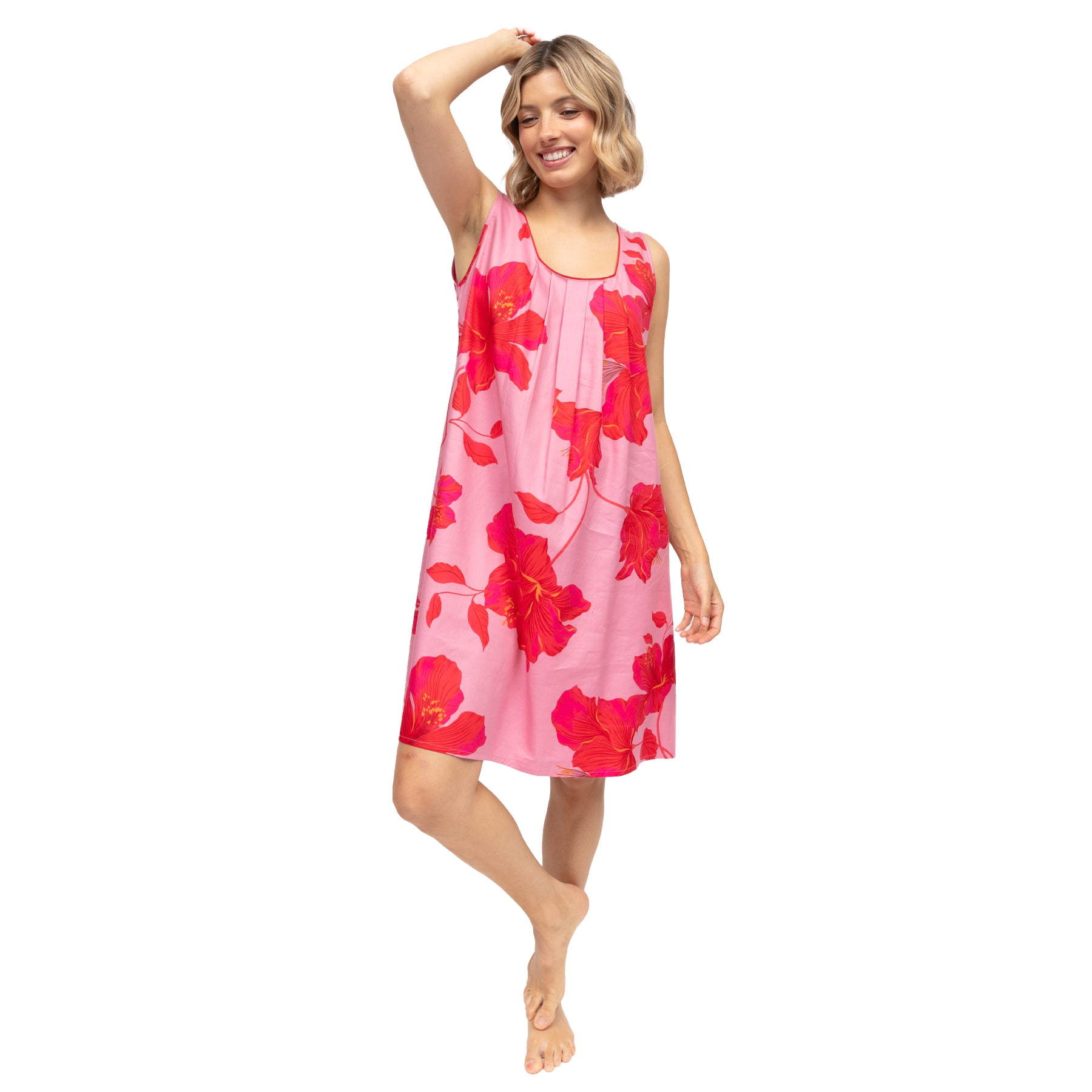 Pink hibiscus print chemise nightgown, flowy knee-length silhouette, styled on model with soft drape