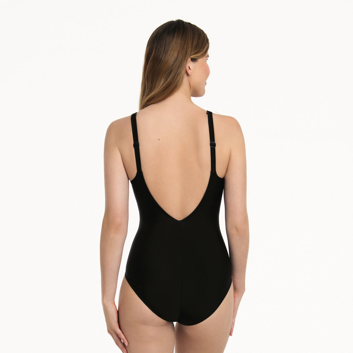 Black and white one-piece swimsuit with solid black back, low V-back and adjustable shoulder straps.