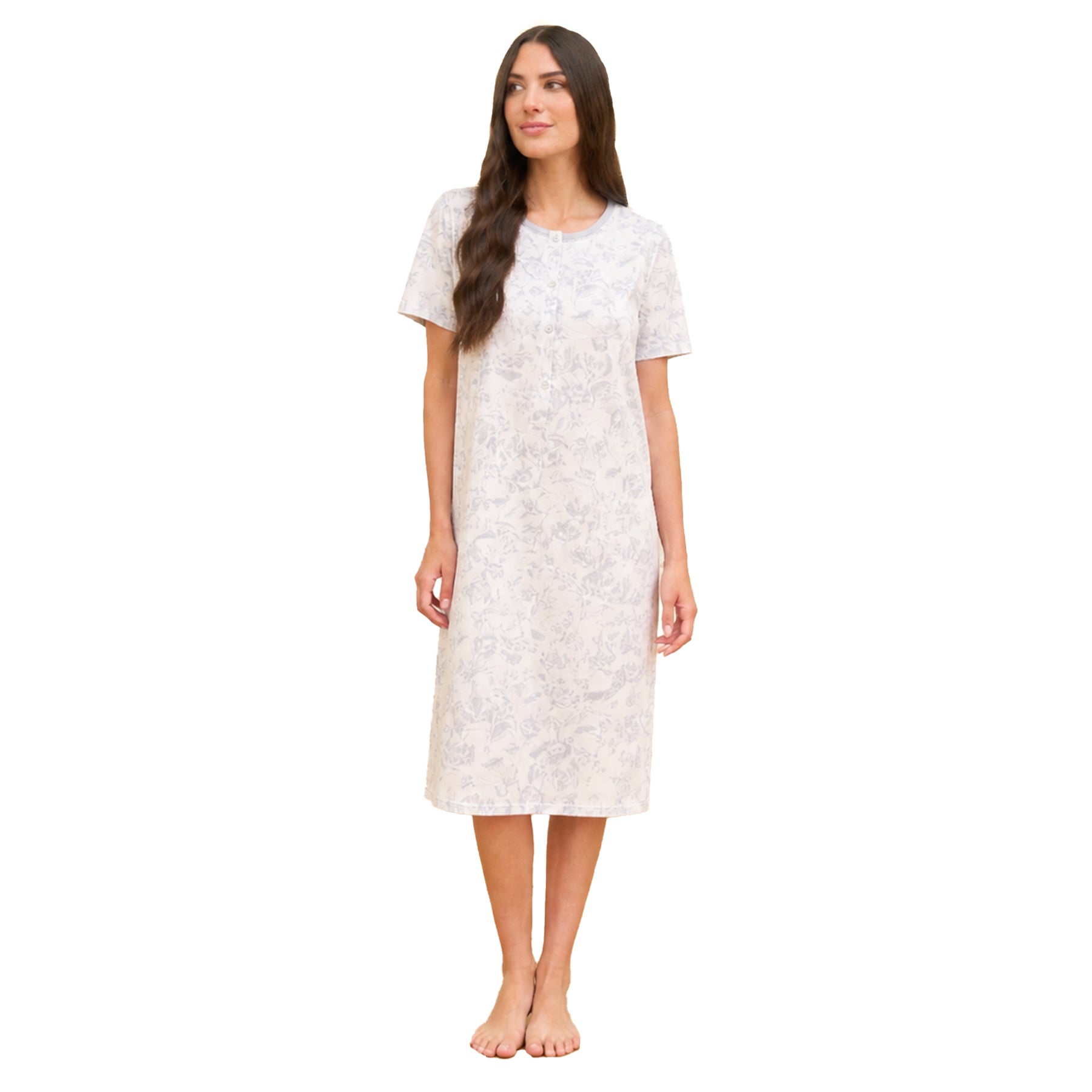 Woman standing against a white background wearing a short-sleeve ivory cotton nightgown with a soft grey floral print and button-front neckline, shown in a clean studio setting.