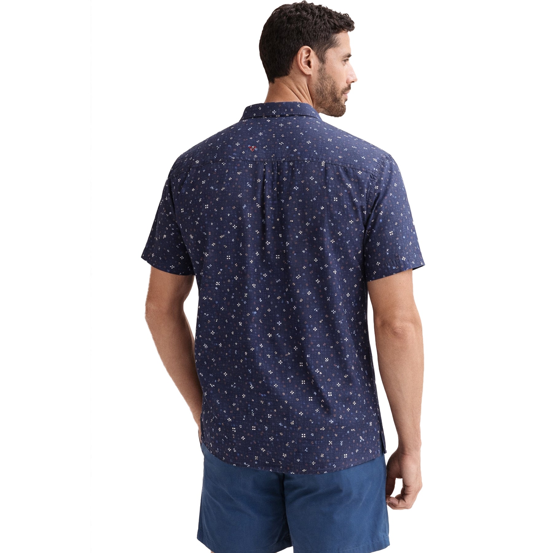 Back view of navy micro-print short sleeve shirt worn with blue shorts