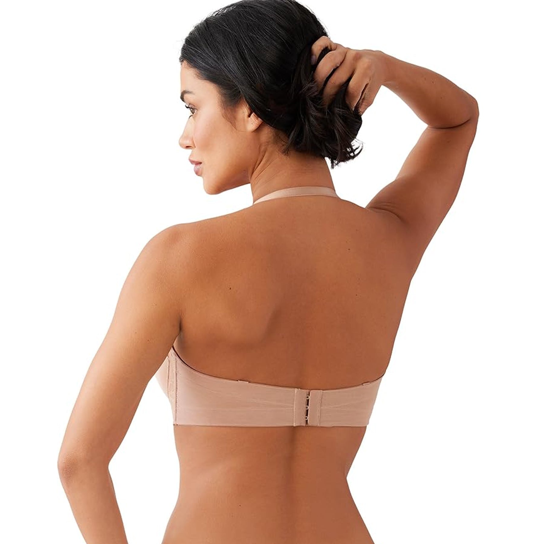 Side-back view of nude strapless bra with clean band finish and secure fit on model