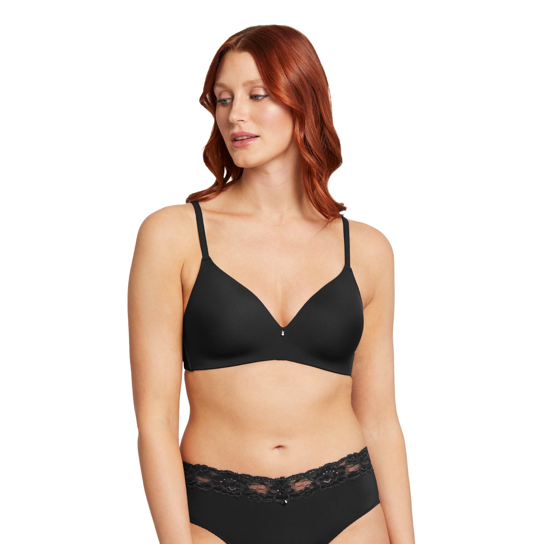 Front view of a black wireless bra with smooth seamless cups, adjustable straps, and a small centre charm, worn by a model on a white background.