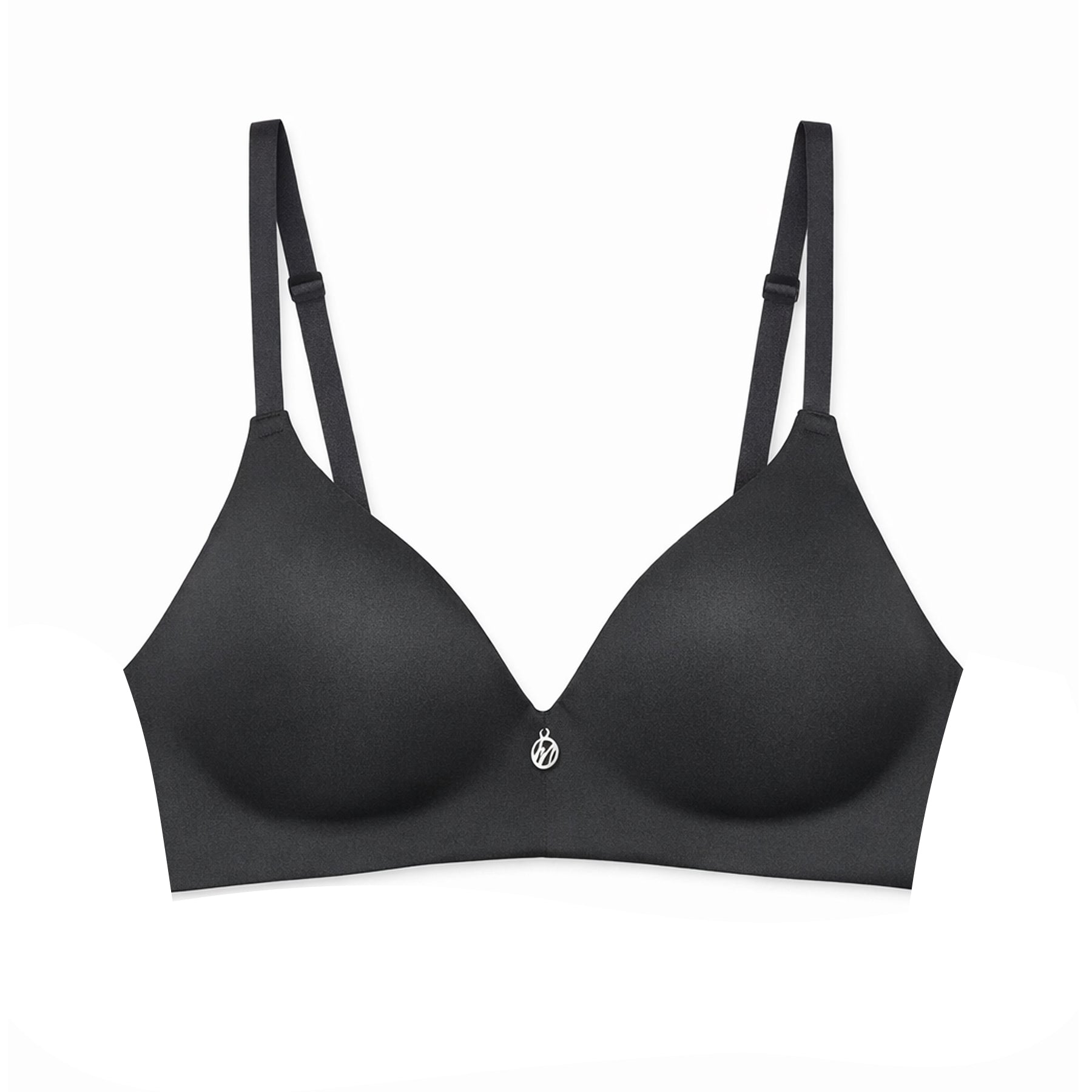 Flat lay of the black seamless wireless bra on a white background, showing the moulded cups, adjustable straps, and centre charm.