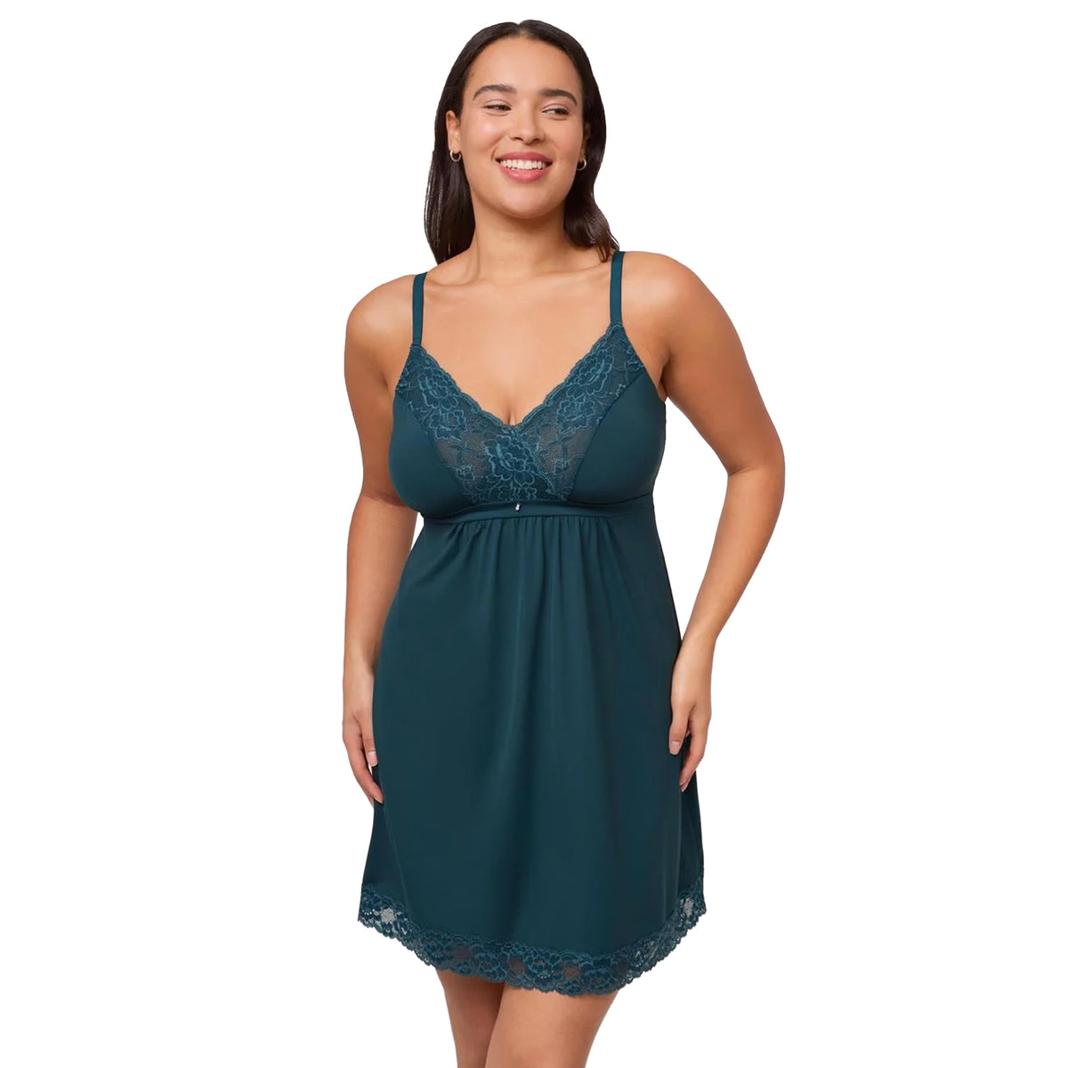 Model wearing a deep spruce green chemise with floral lace V-neckline, adjustable straps, empire waist and lace-trimmed hem, front view.