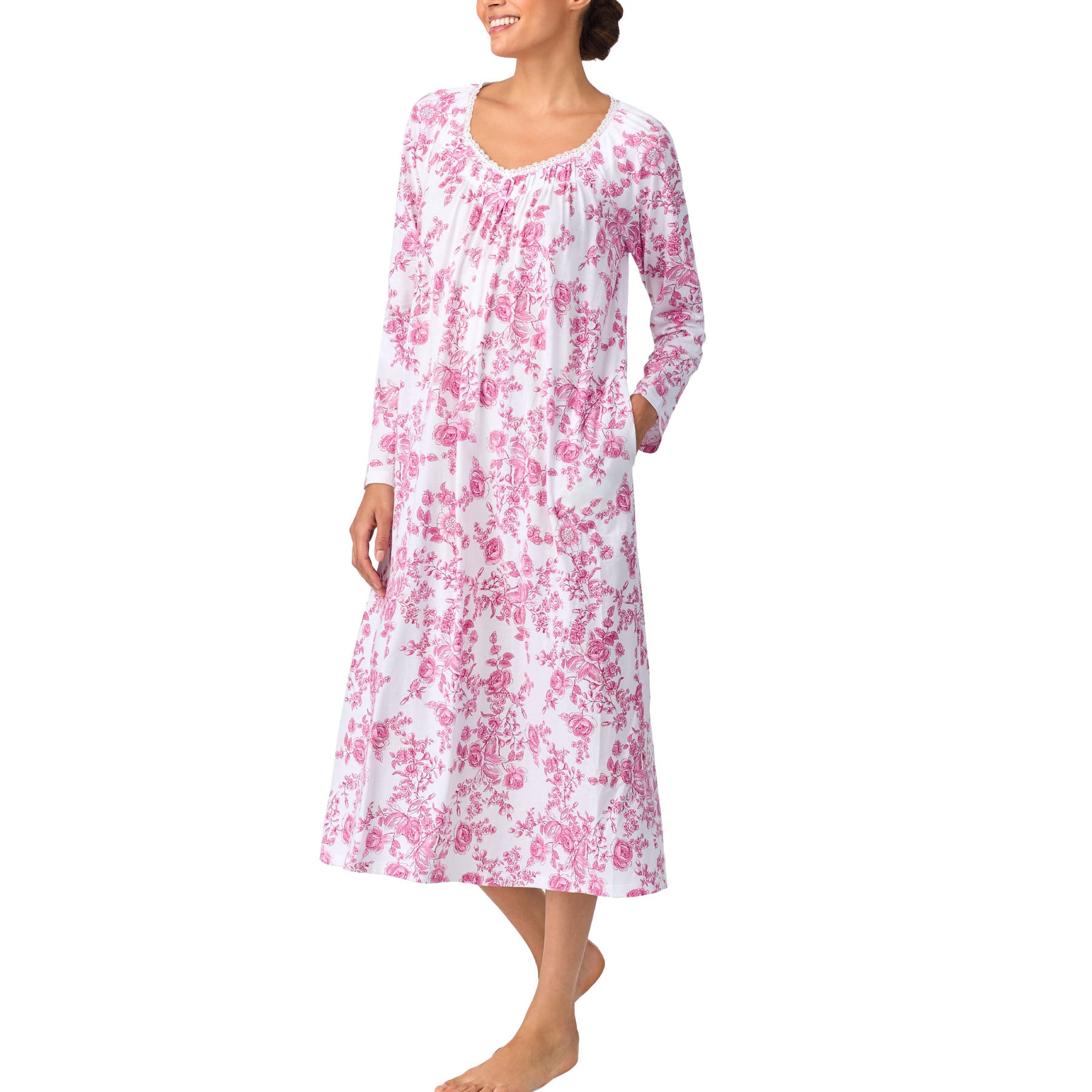 Woman wearing a pink floral nightgown on a white background