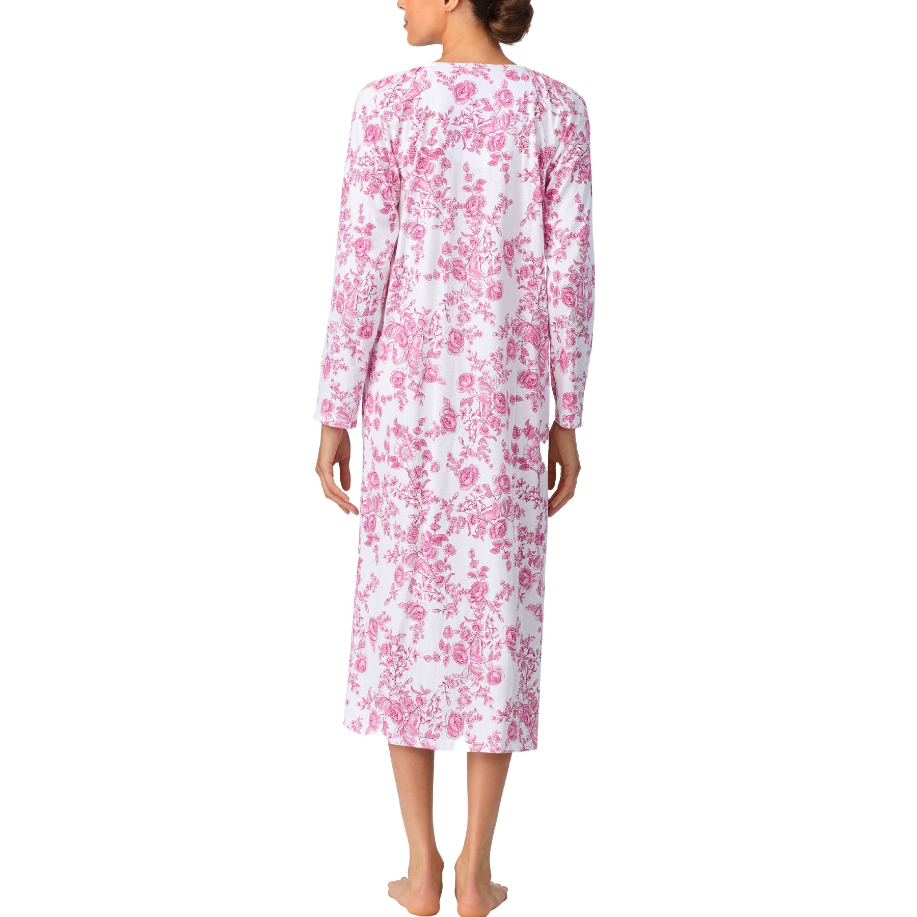 Woman wearing a pink floral nightgown on a white background