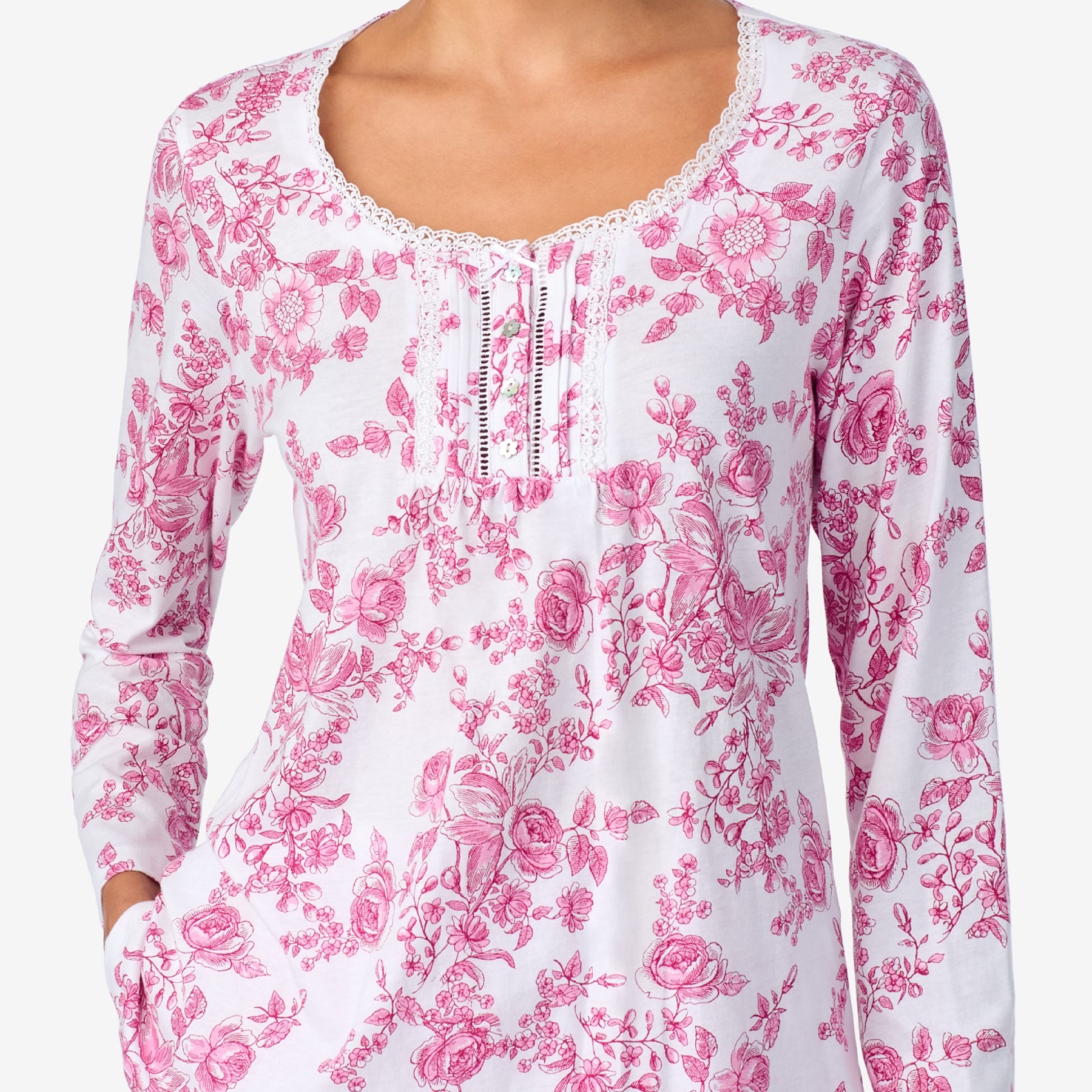 White long-sleeve top with pink floral pattern on a white background
