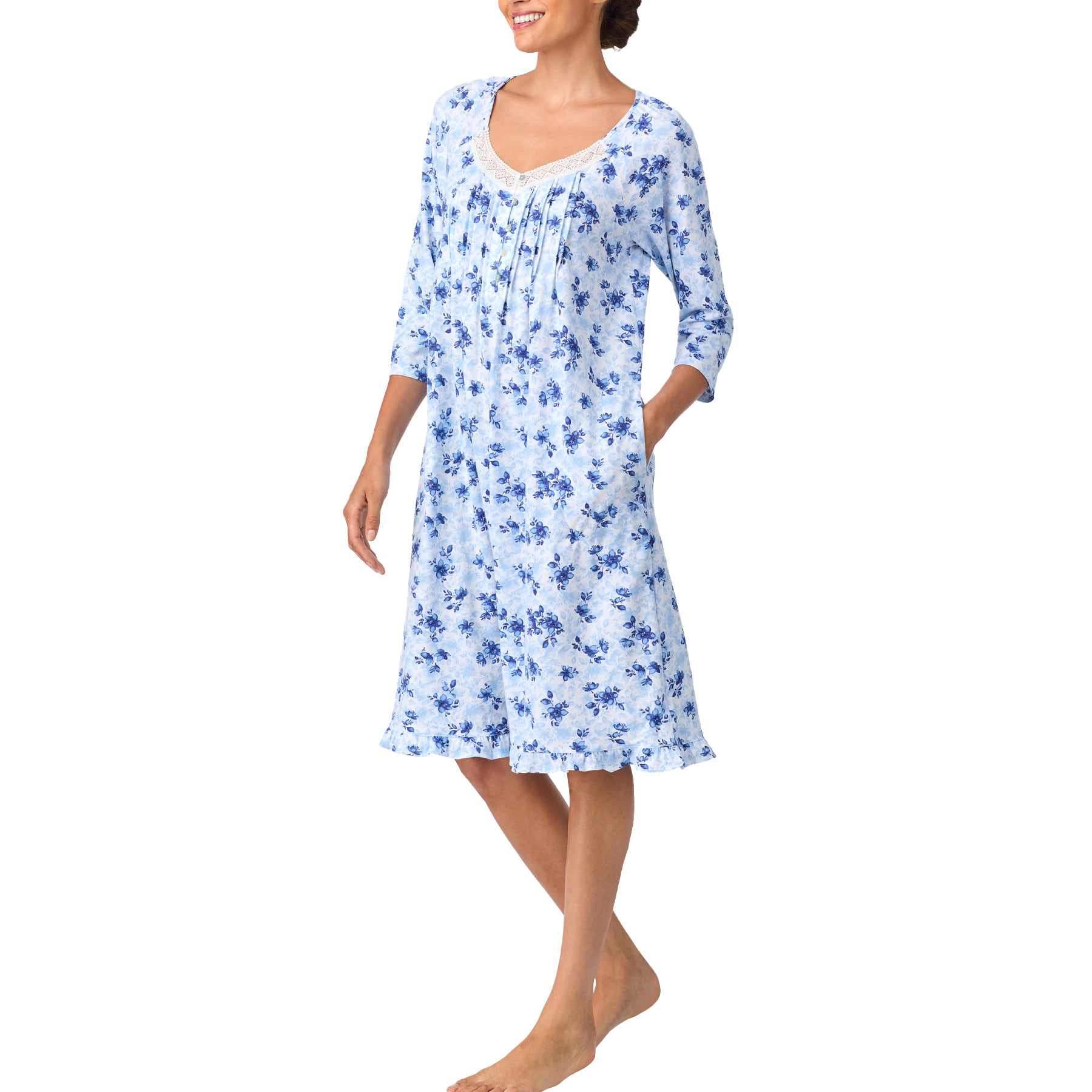 Woman wearing a blue floral nightgown on a white background