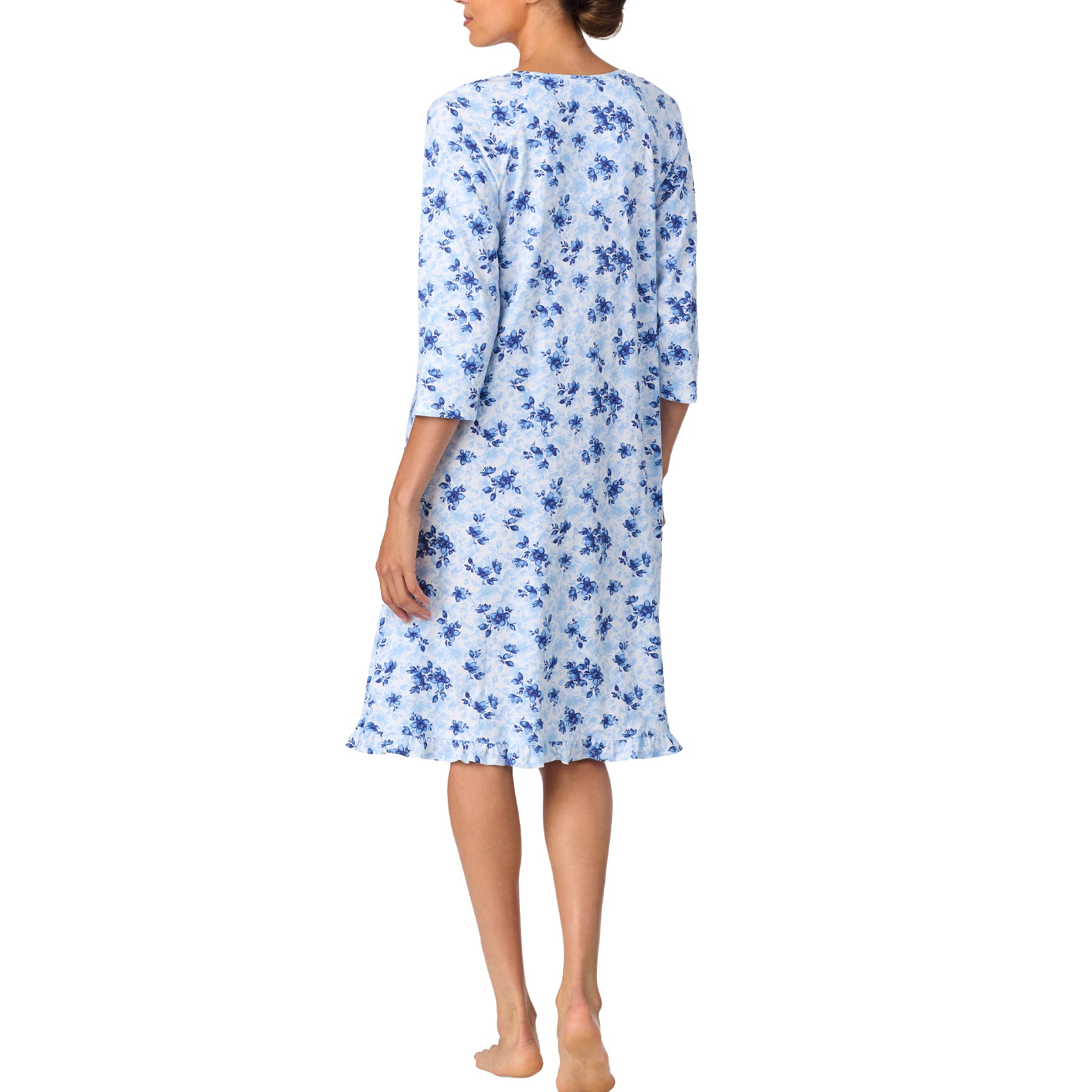 Woman wearing a blue floral dress on a white background