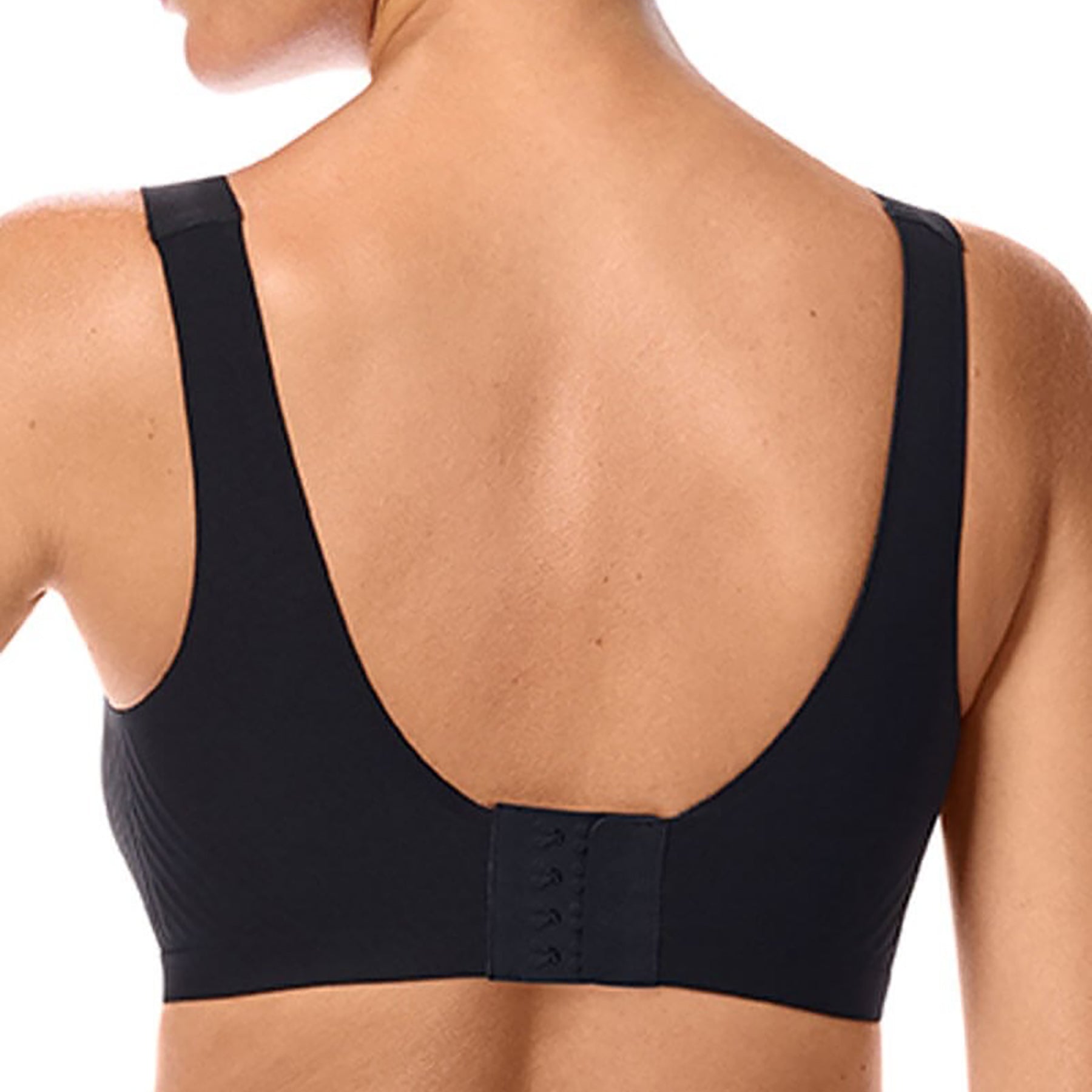 Model wearing Amoena Linda wireless seamless bra in black, back view showing smooth coverage and supportive wide band