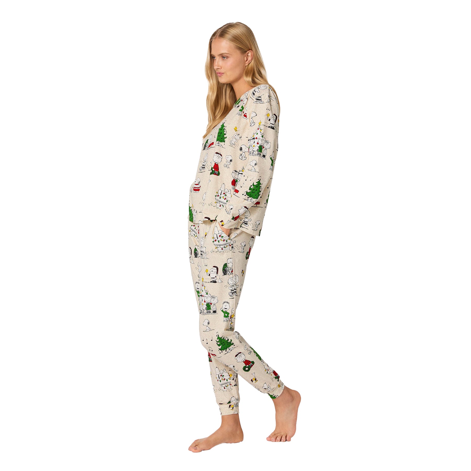 Woman wearing a festive pajama set with Christmas-themed design on a white background