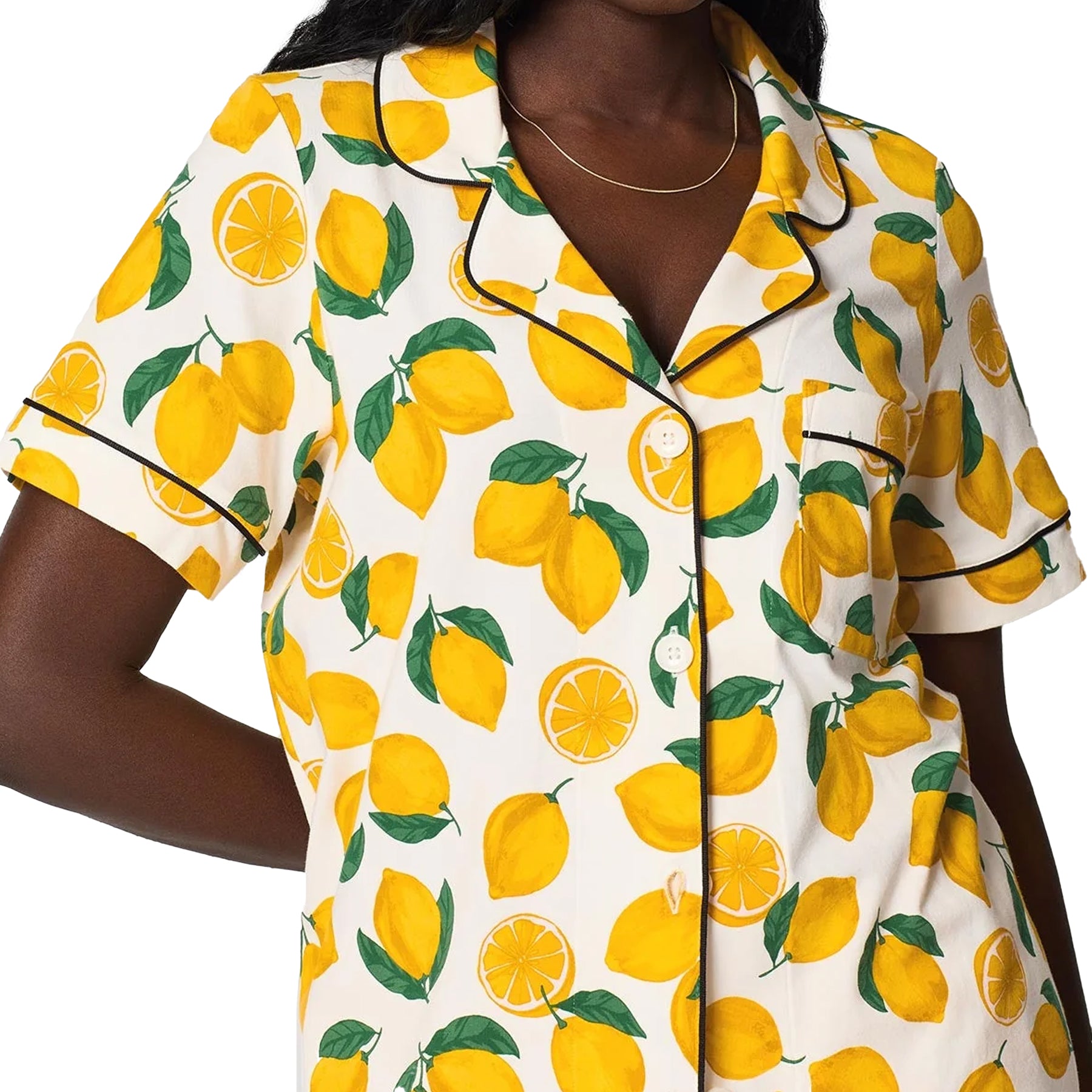 Close-up of lemon print sleep shirt featuring button-front styling, pocket detail, and black piping accents.