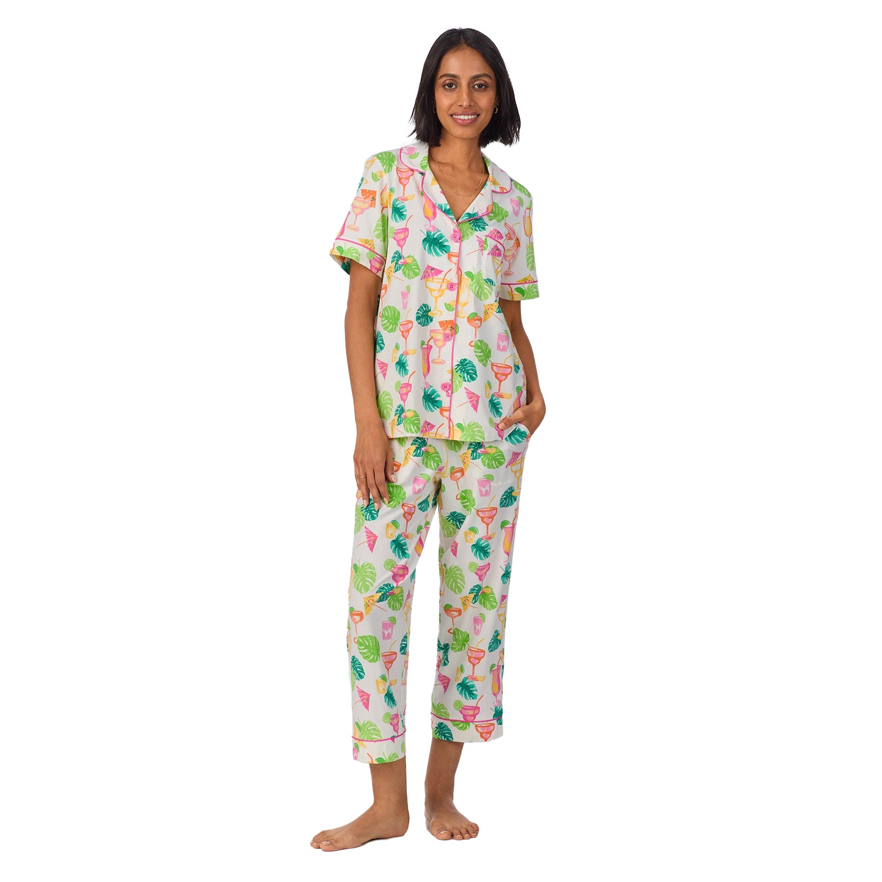 Front-facing view of a model smiling in the tropical cocktail print pyjama set with a cheerful, summery vibe.