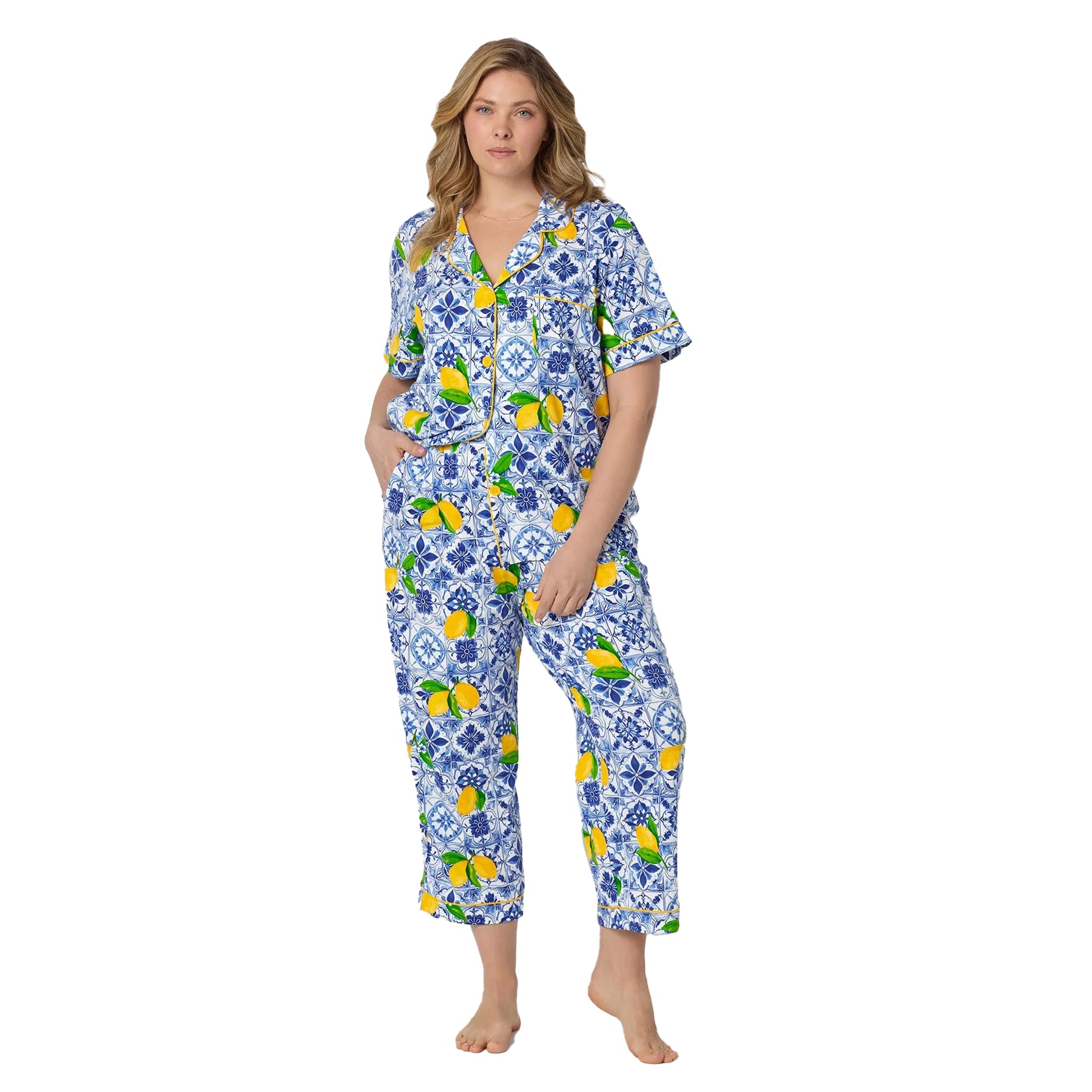 Woman wearing Bedhead blue tile and lemon print pajama set with cropped pants and soft cotton feel.