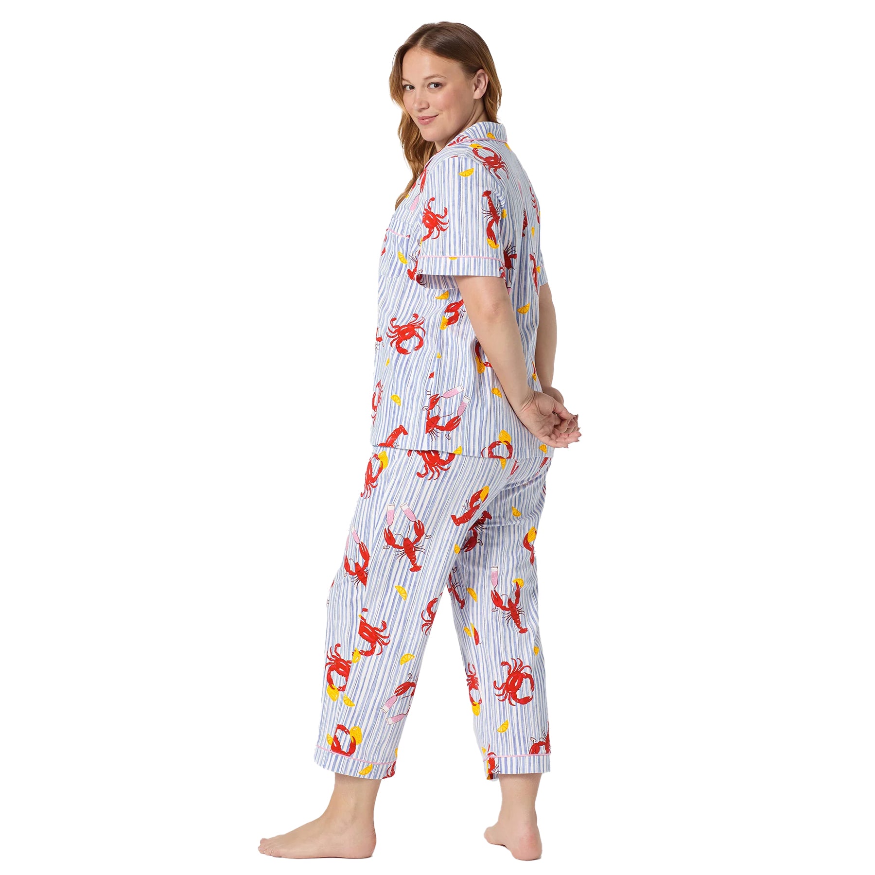Back view of a striped pyjama set with red lobster and crab print, relaxed short sleeve shirt, and cropped lounge pants.